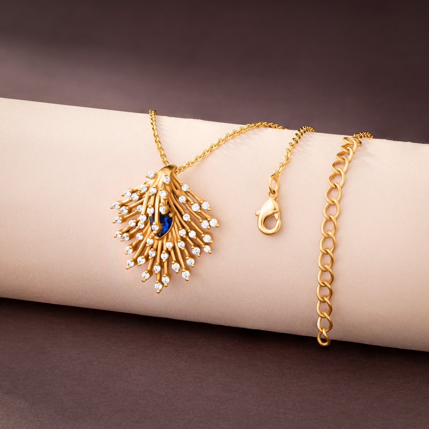 golden necklace with a blue stone pendant