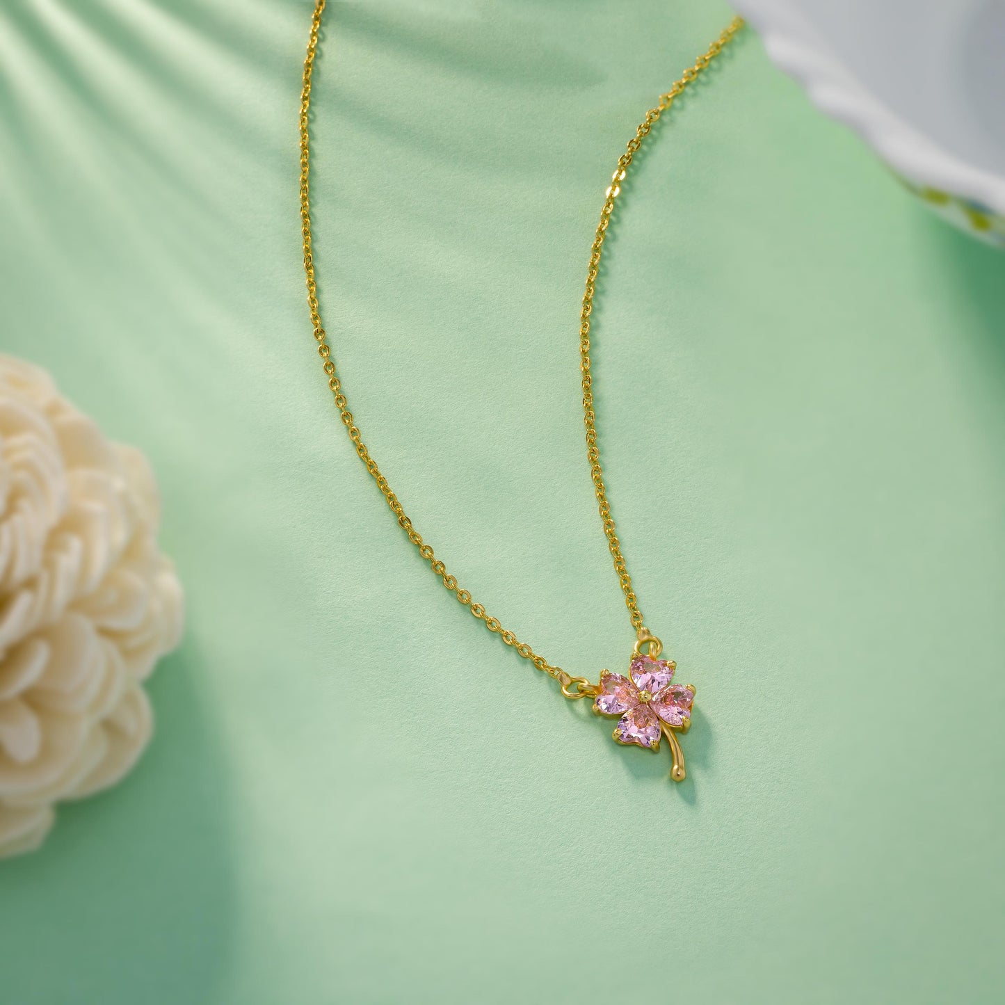 golden necklace featuring a four-leaf clover pendant