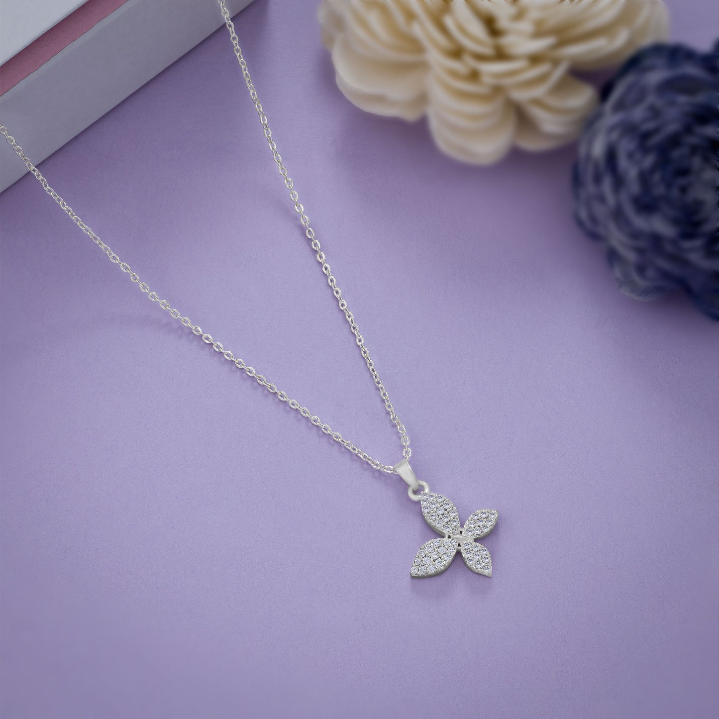 silver necklace with a diamond butterfly pendant