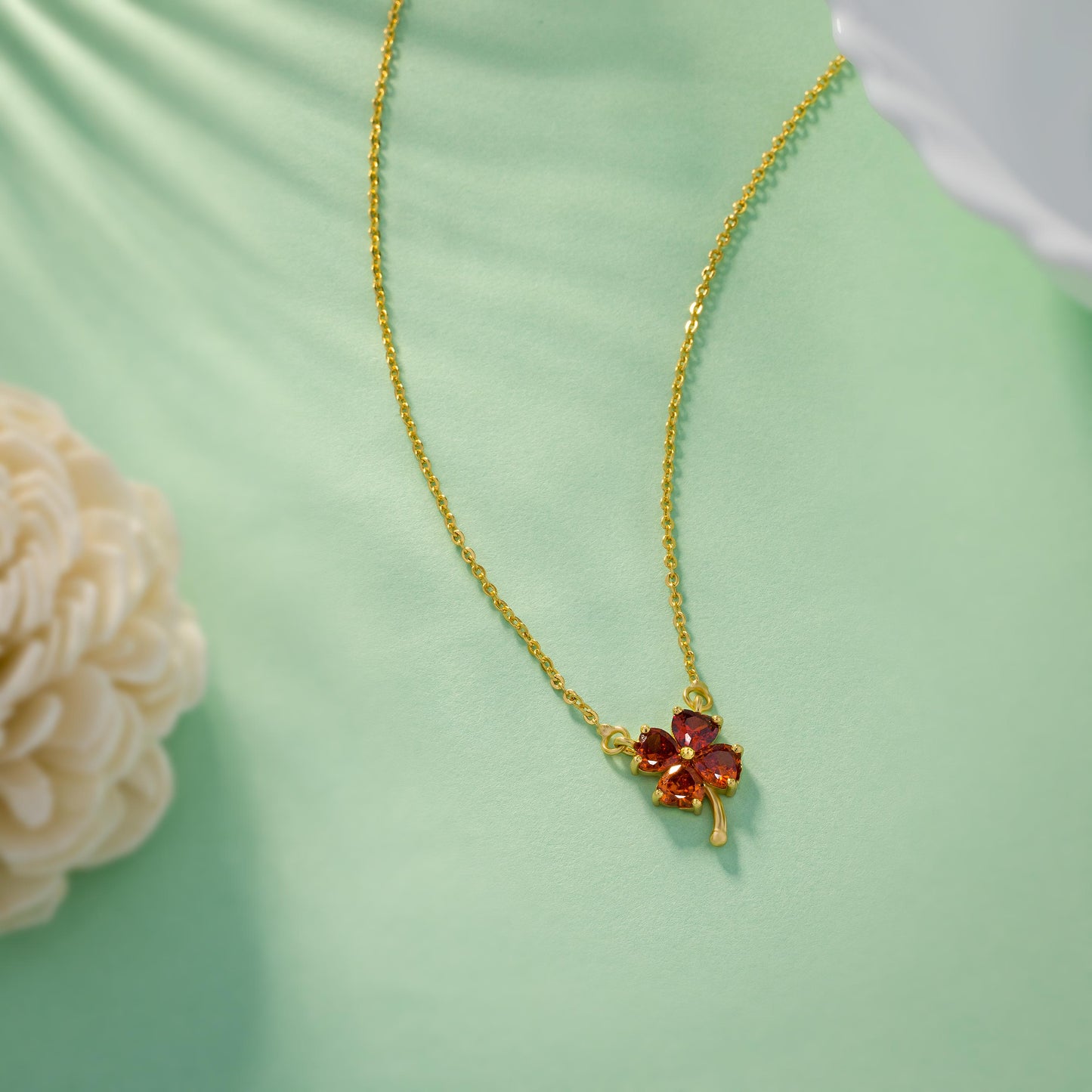 golden necklace featuring a four-leaf clover pendant