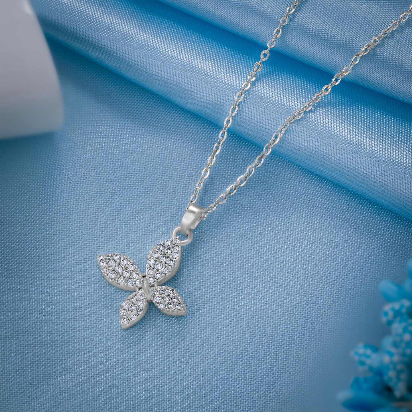 silver necklace with a diamond butterfly pendant