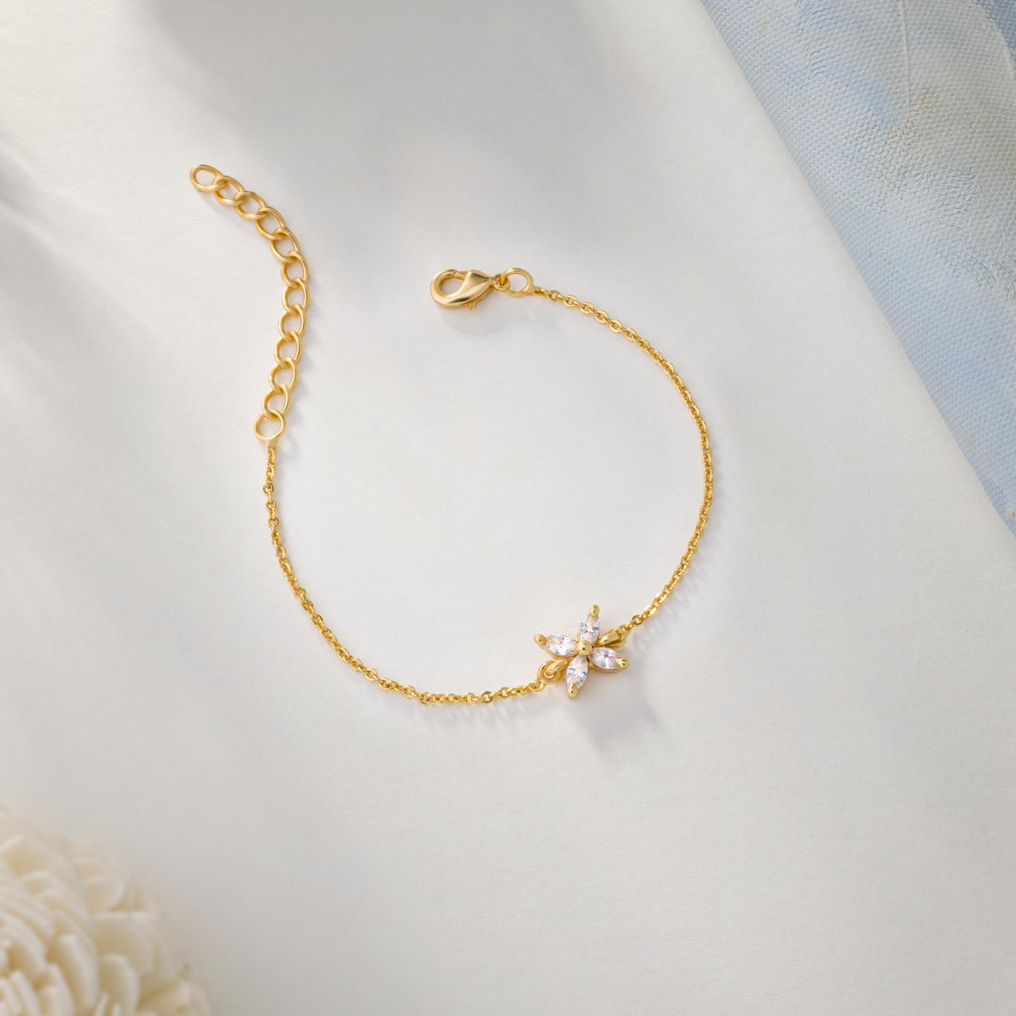 golden bracelet with a small white butterfly