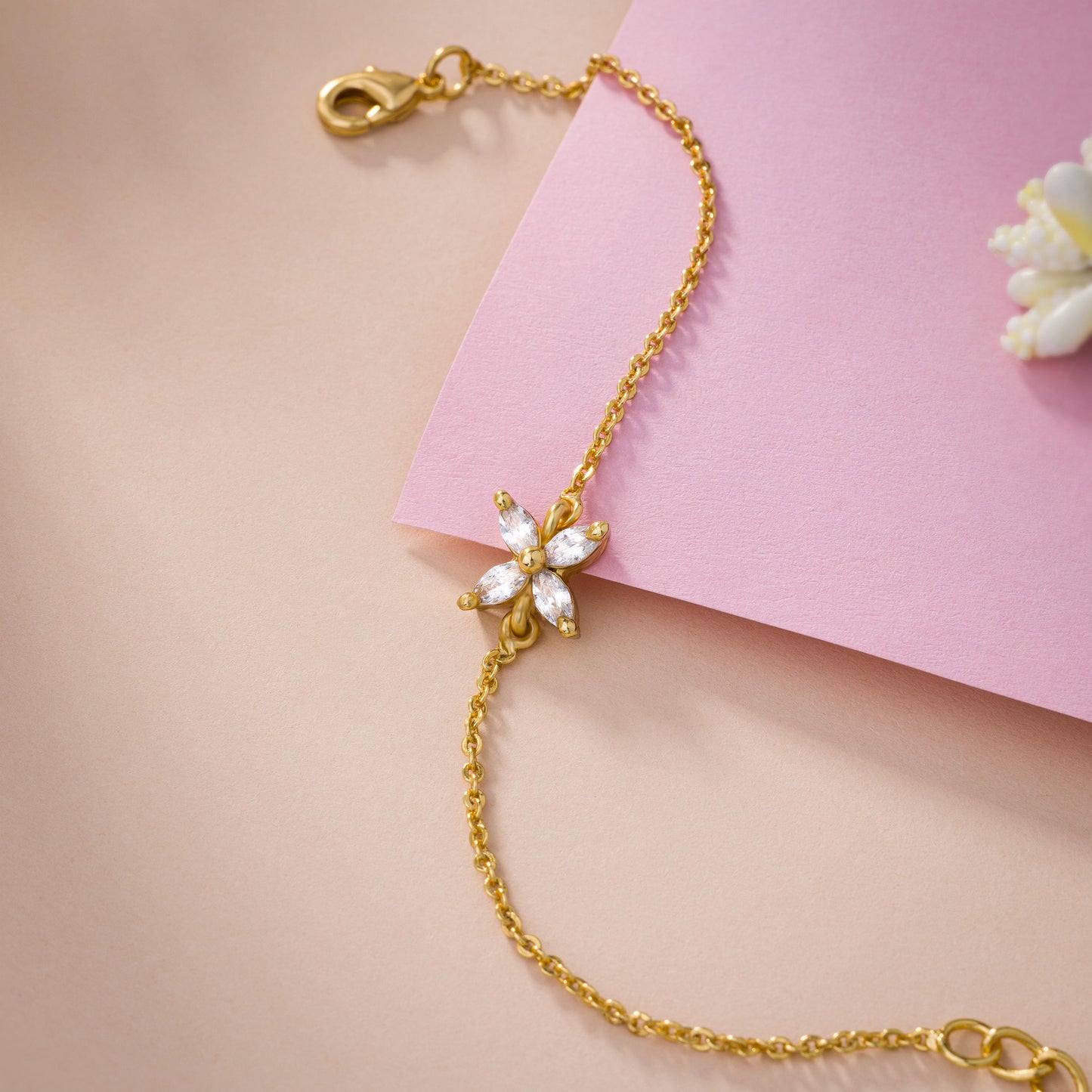 golden bracelet with a small white butterfly