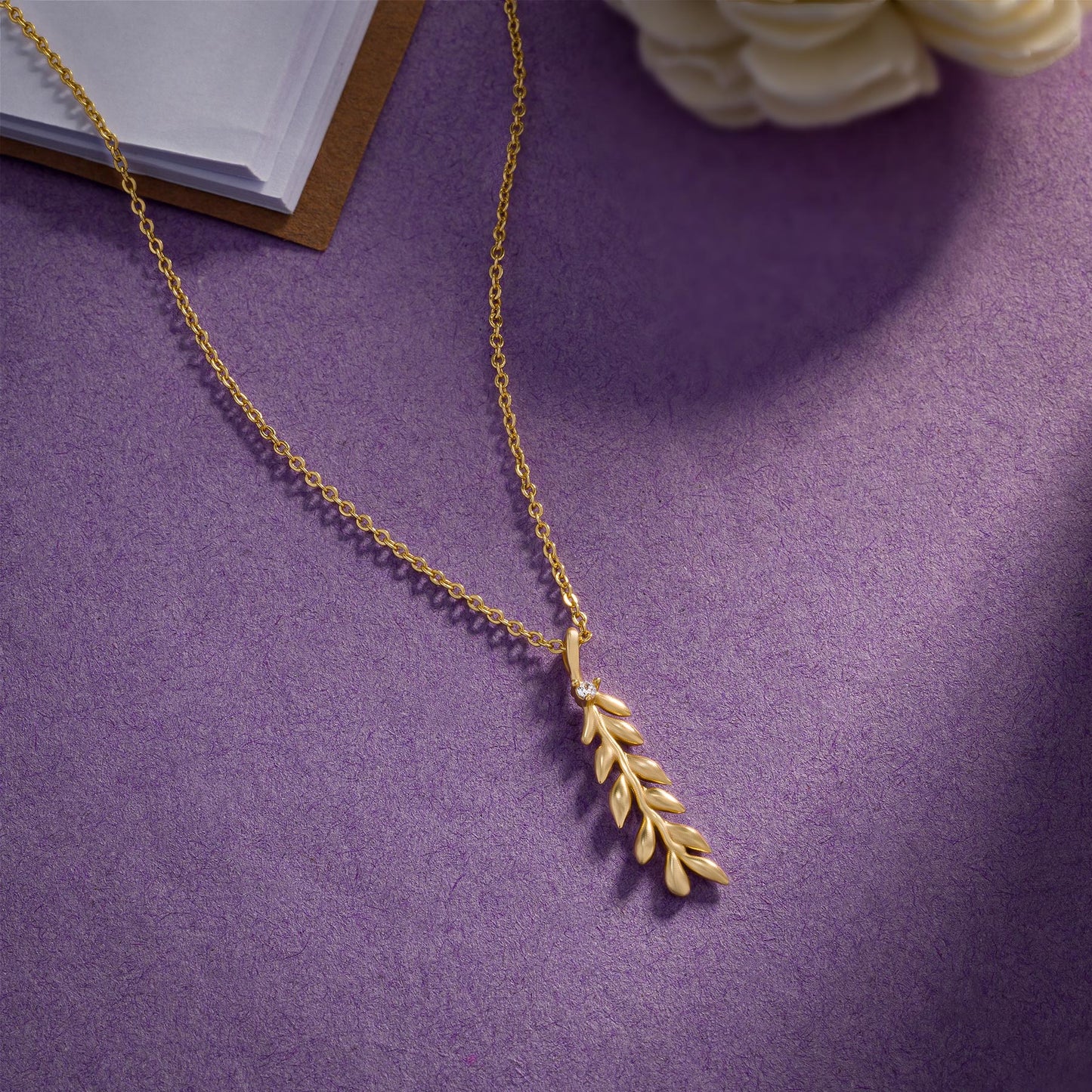 golden necklace with leaf pendant