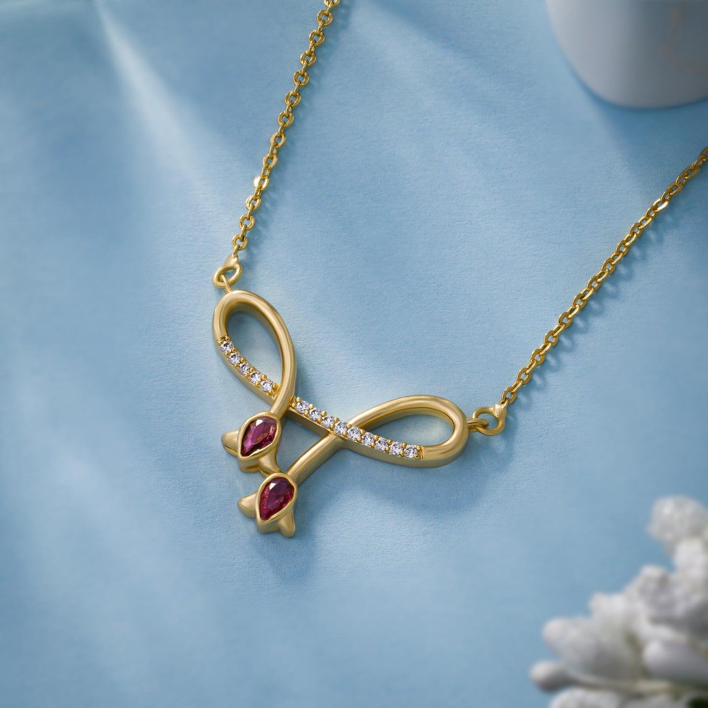 golden necklace with red stone and diamonds