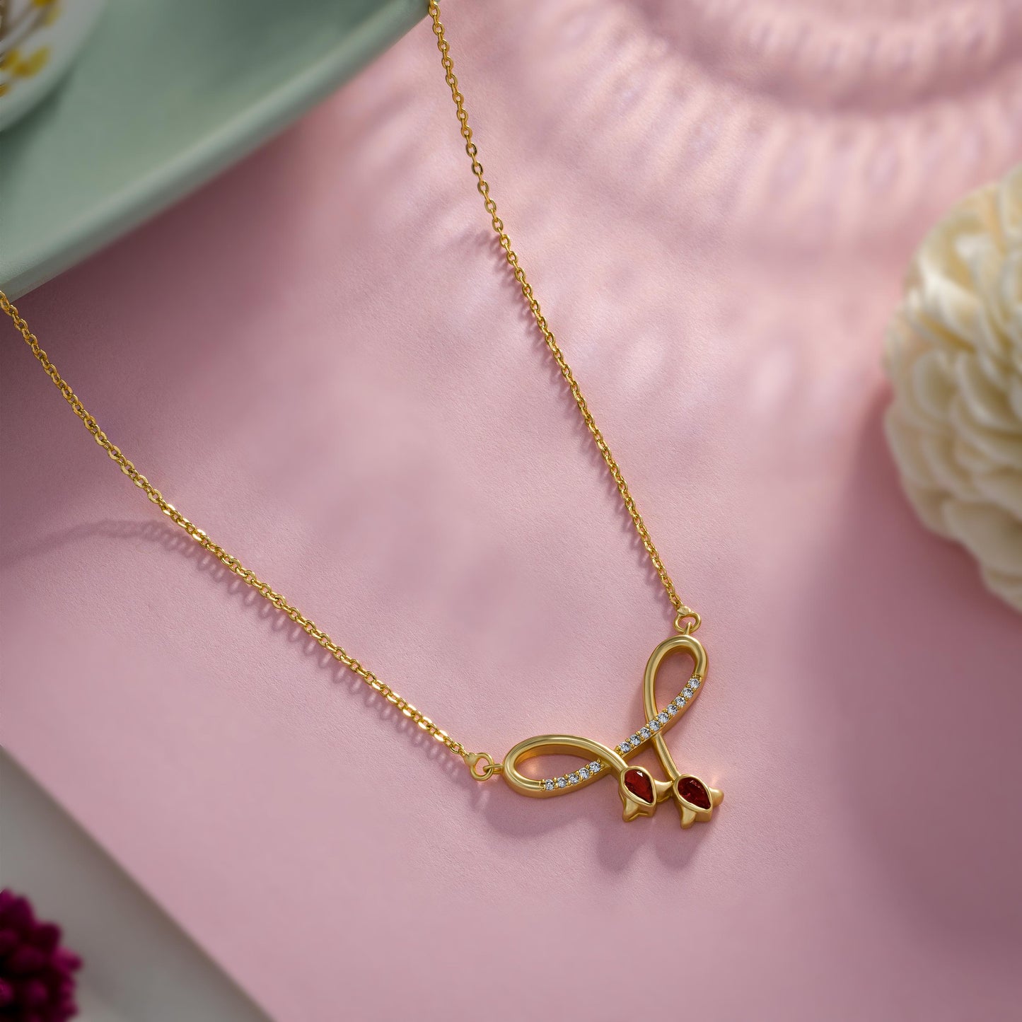 golden necklace with red stone and diamonds