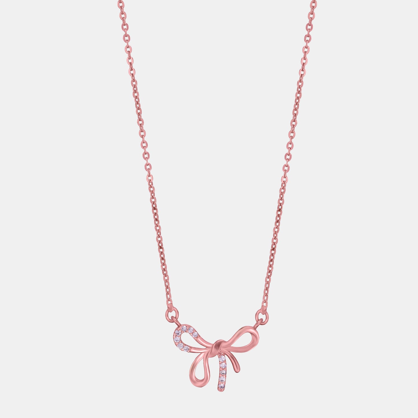 rose gold necklace with a bow on it