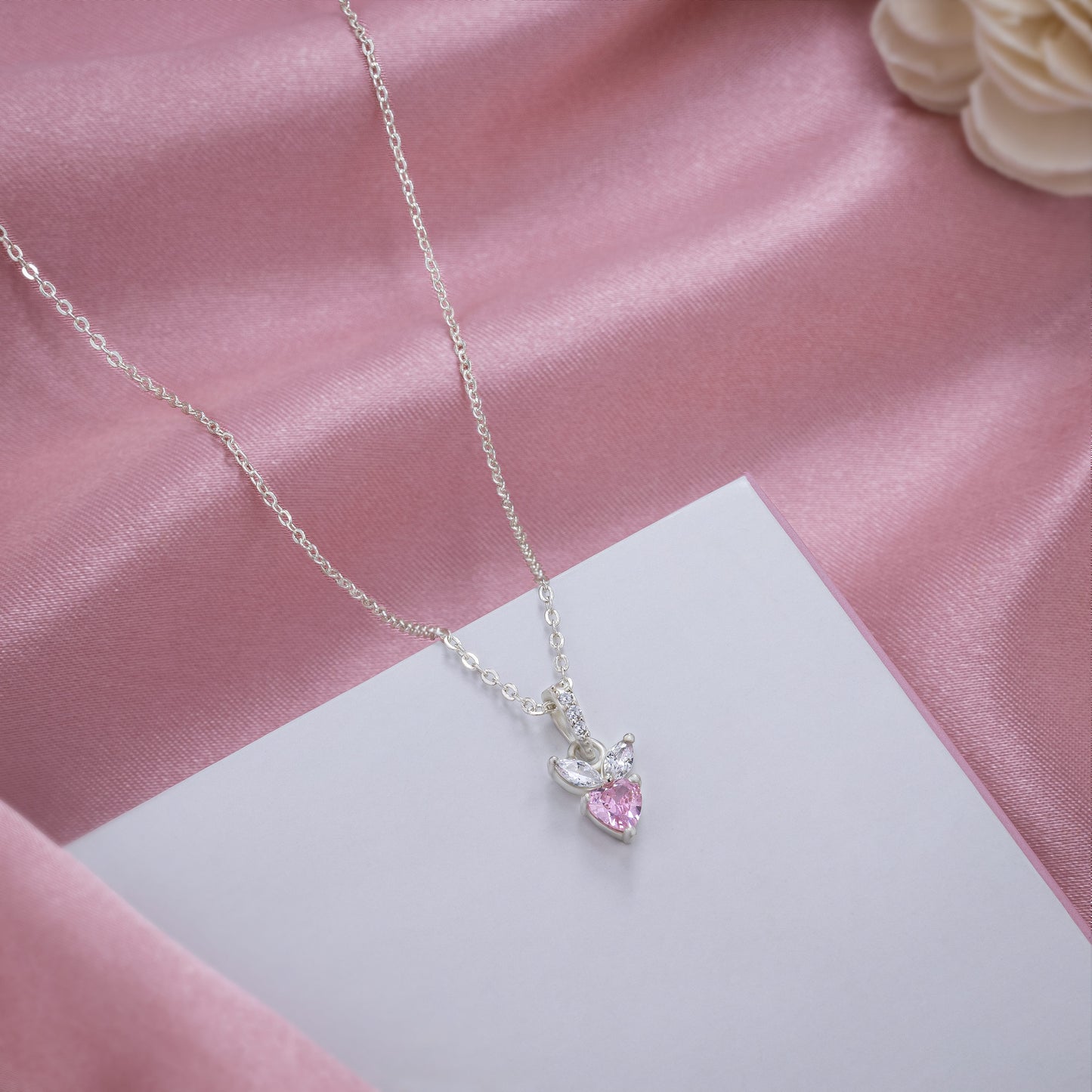 pink diamond pendant on a sleek silver chain