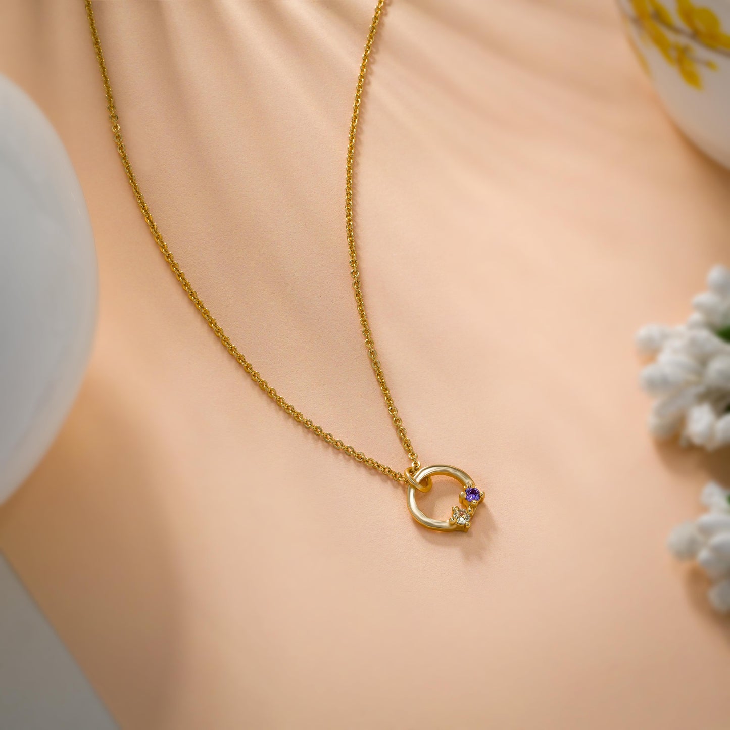 stylish golden necklace featuring circle pendant with white stone