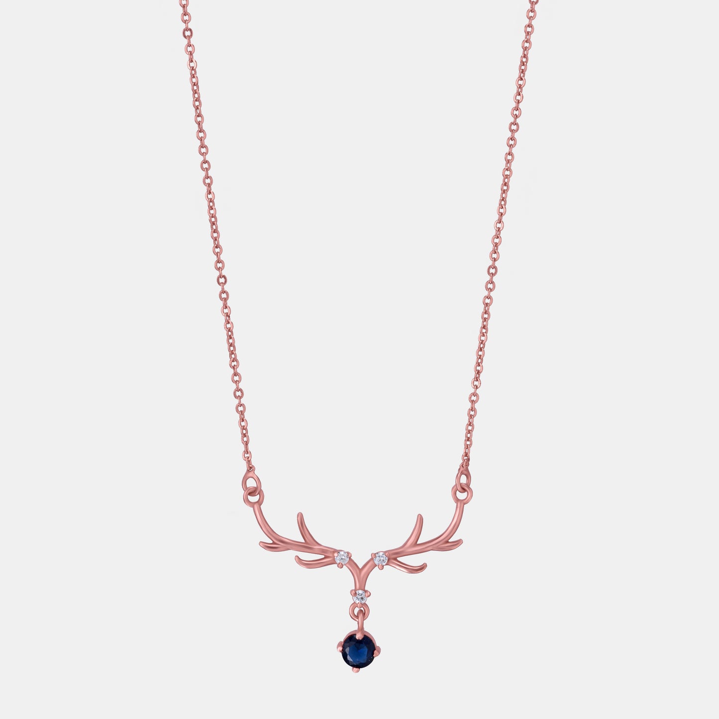 rose gold necklace with a sapphire stone