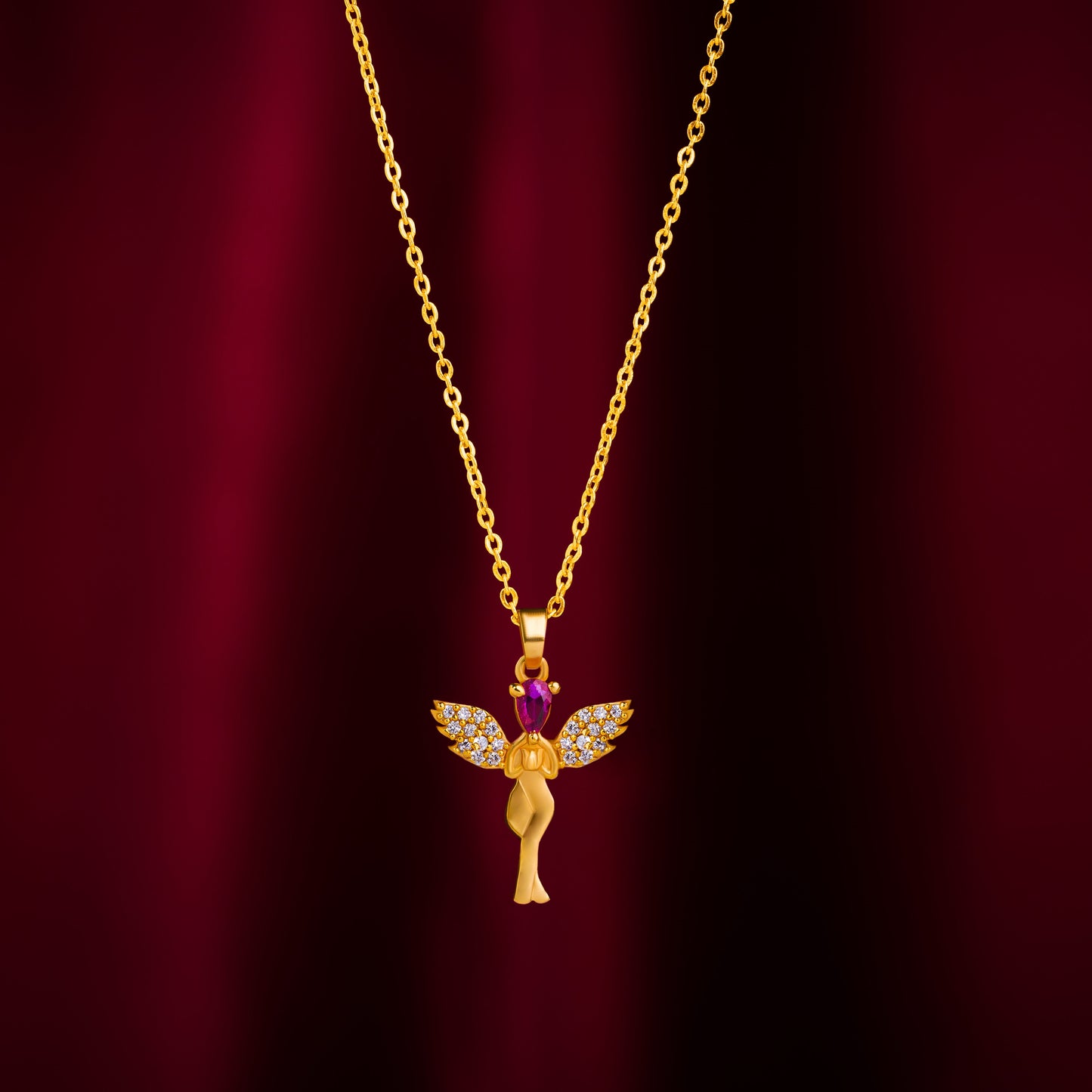 golden necklace with a purple stone angel