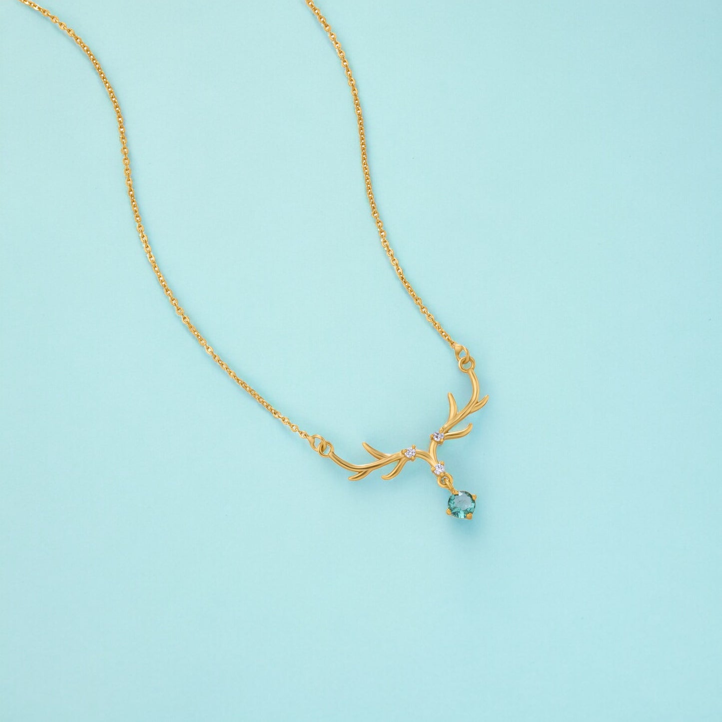 the golden deer necklace with a stone