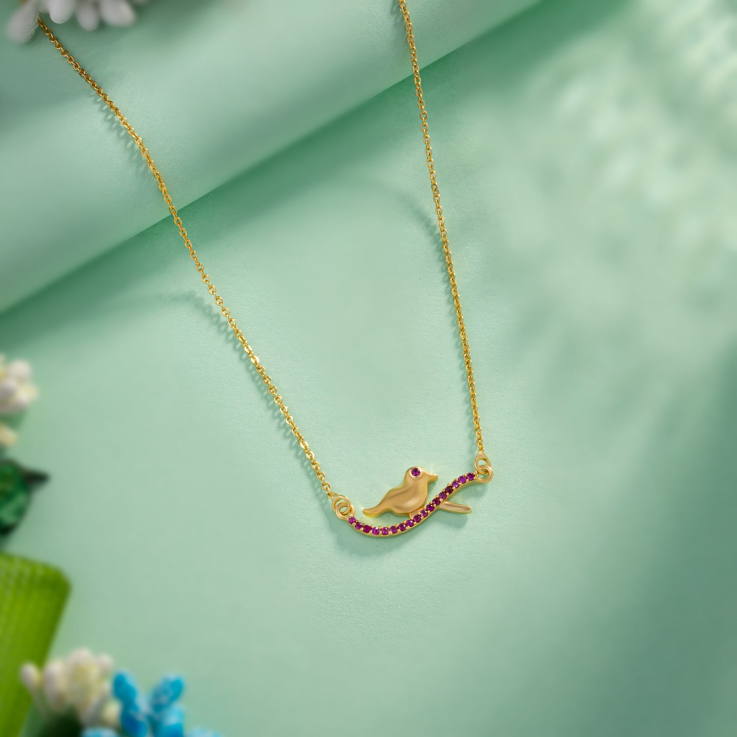 golden bird necklace with pink stones