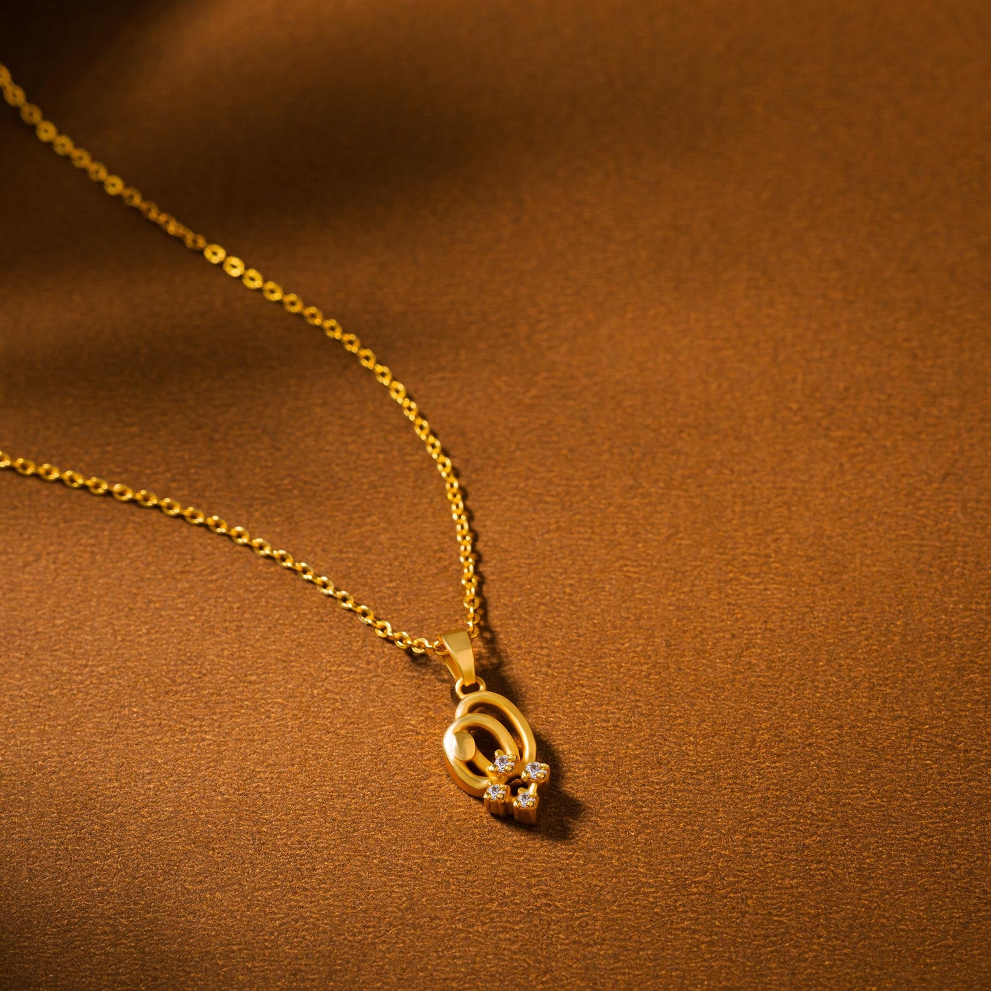 golden necklace with a diamond pendant