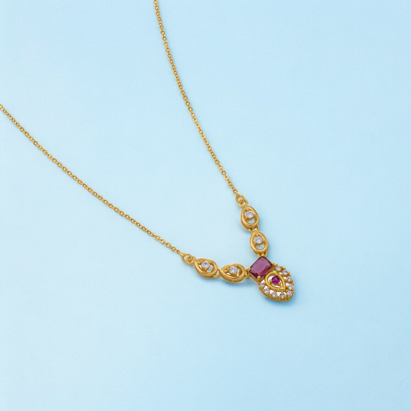 golden necklace with a ruby stone and diamonds