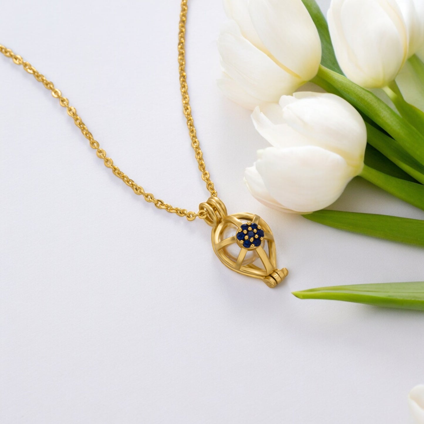 golden necklace with a blue sapphire stone