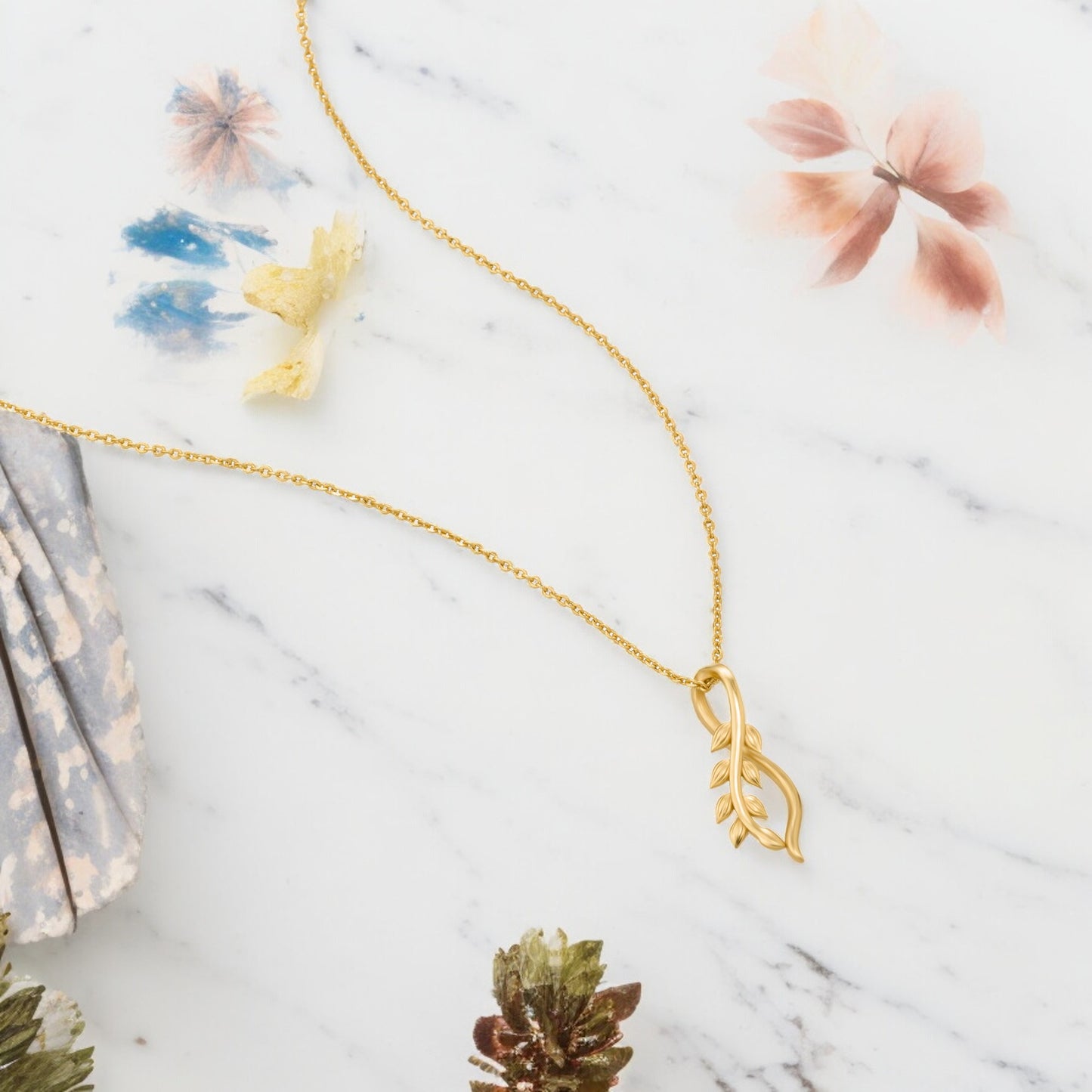 golden necklace with a small leaf on it