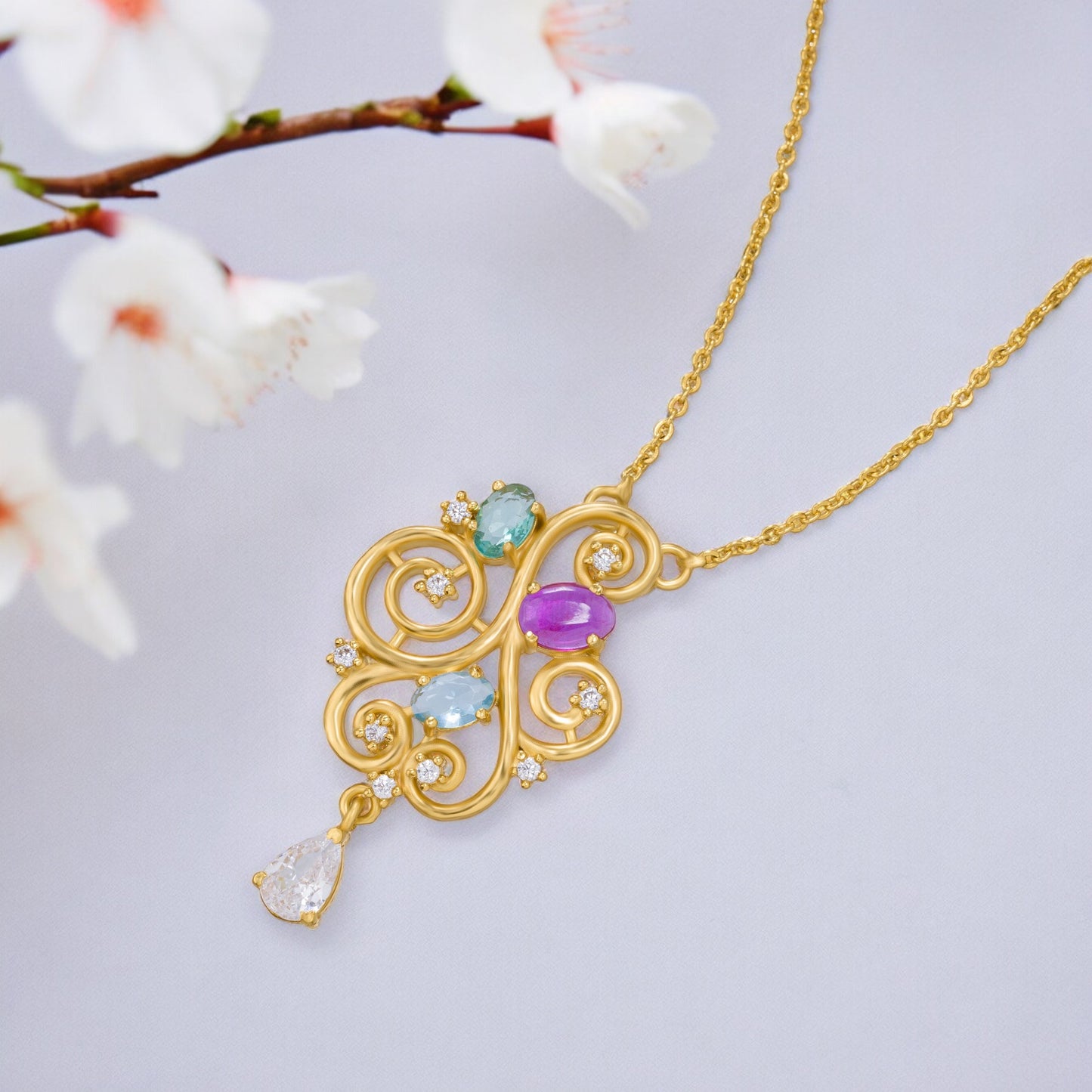 golden necklace with a purple stone and a white diamond