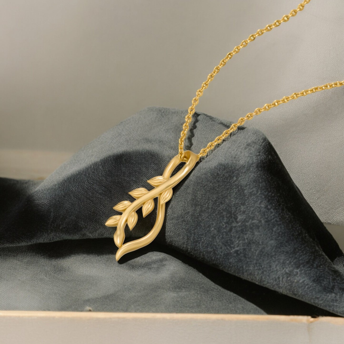 golden necklace with a small leaf on it