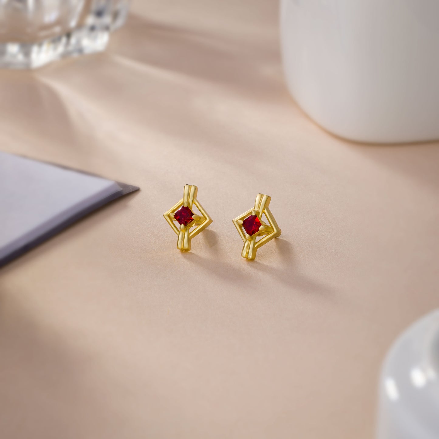 pair of golden earrings with a diamond