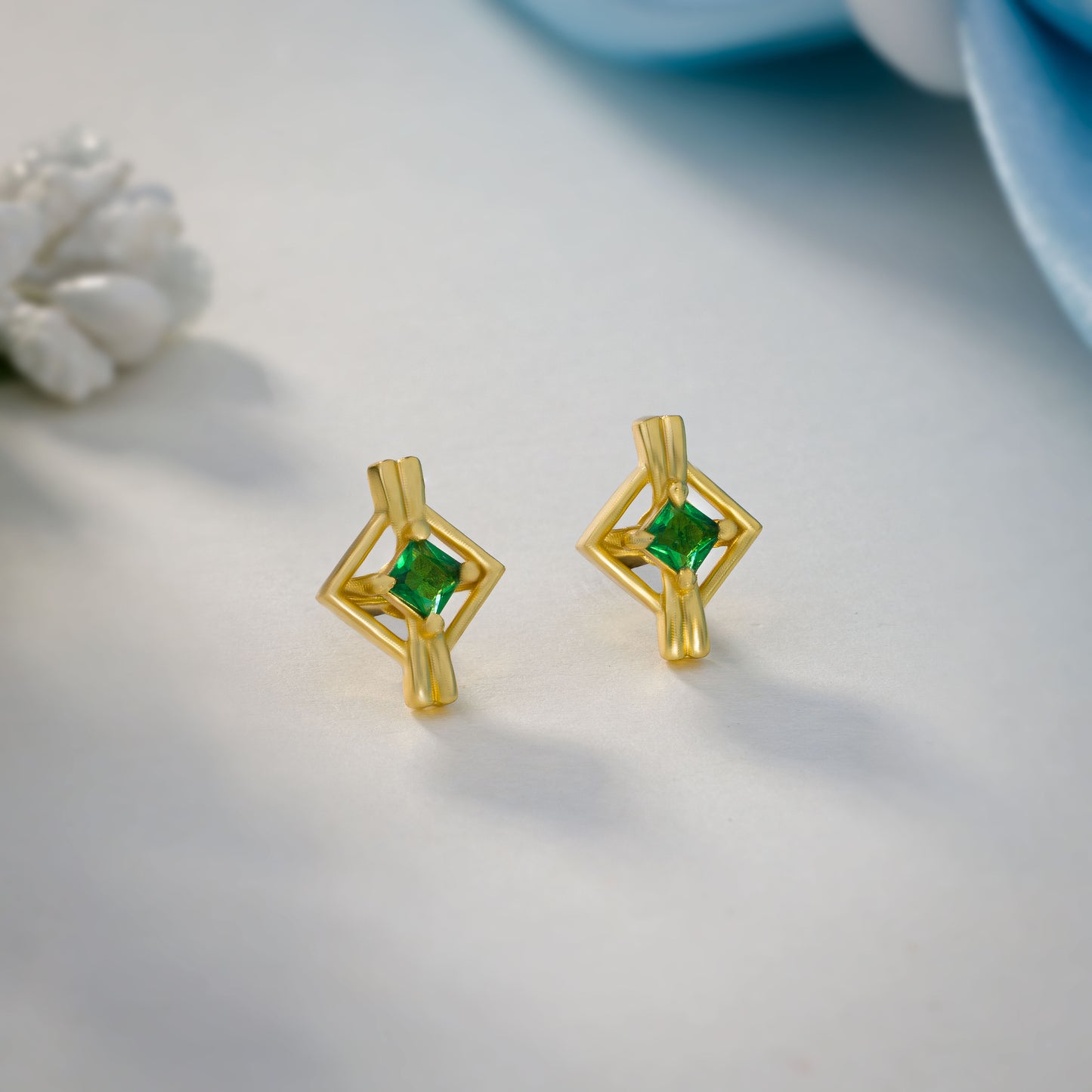 pair of golden earrings with a diamond