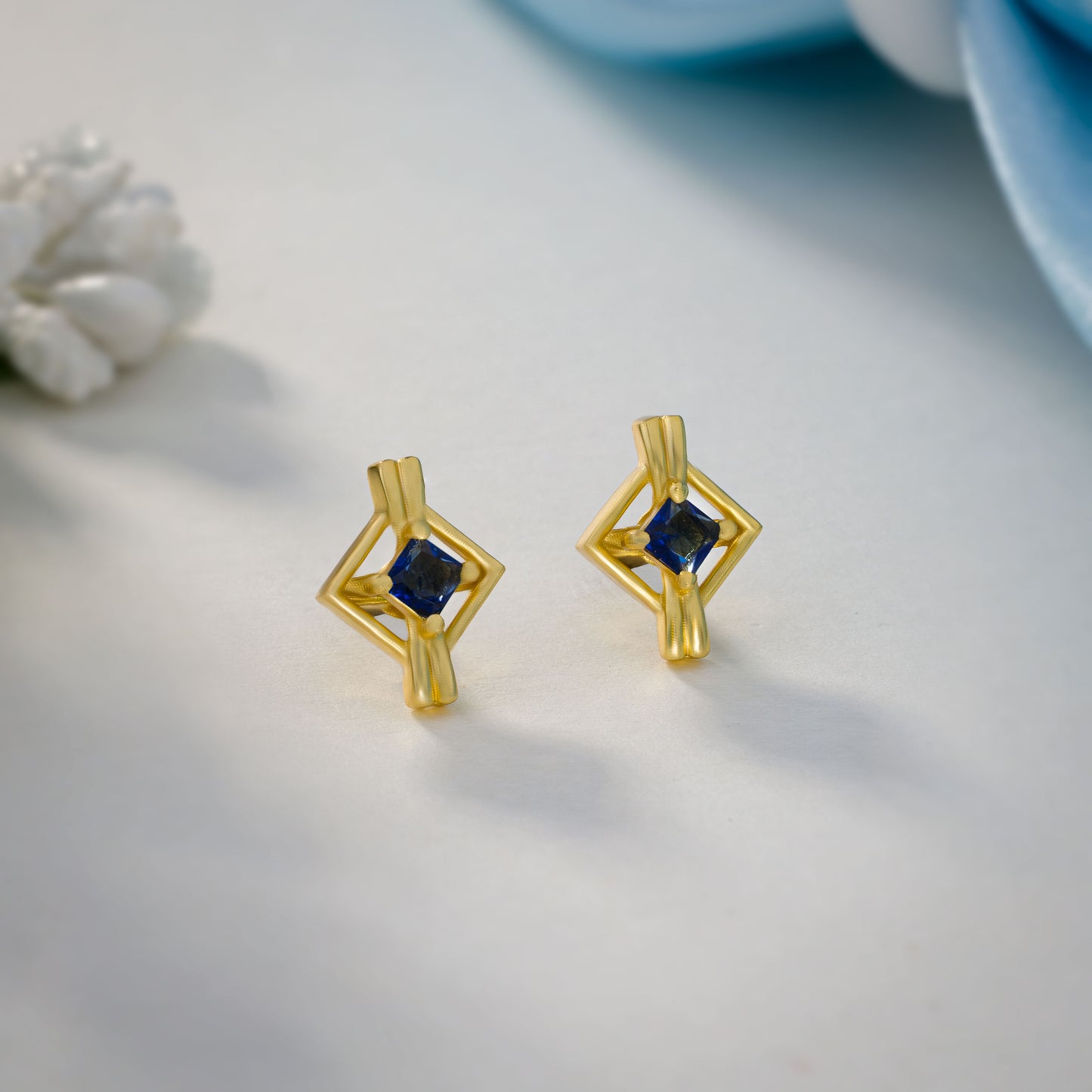 pair of golden earrings with a diamond