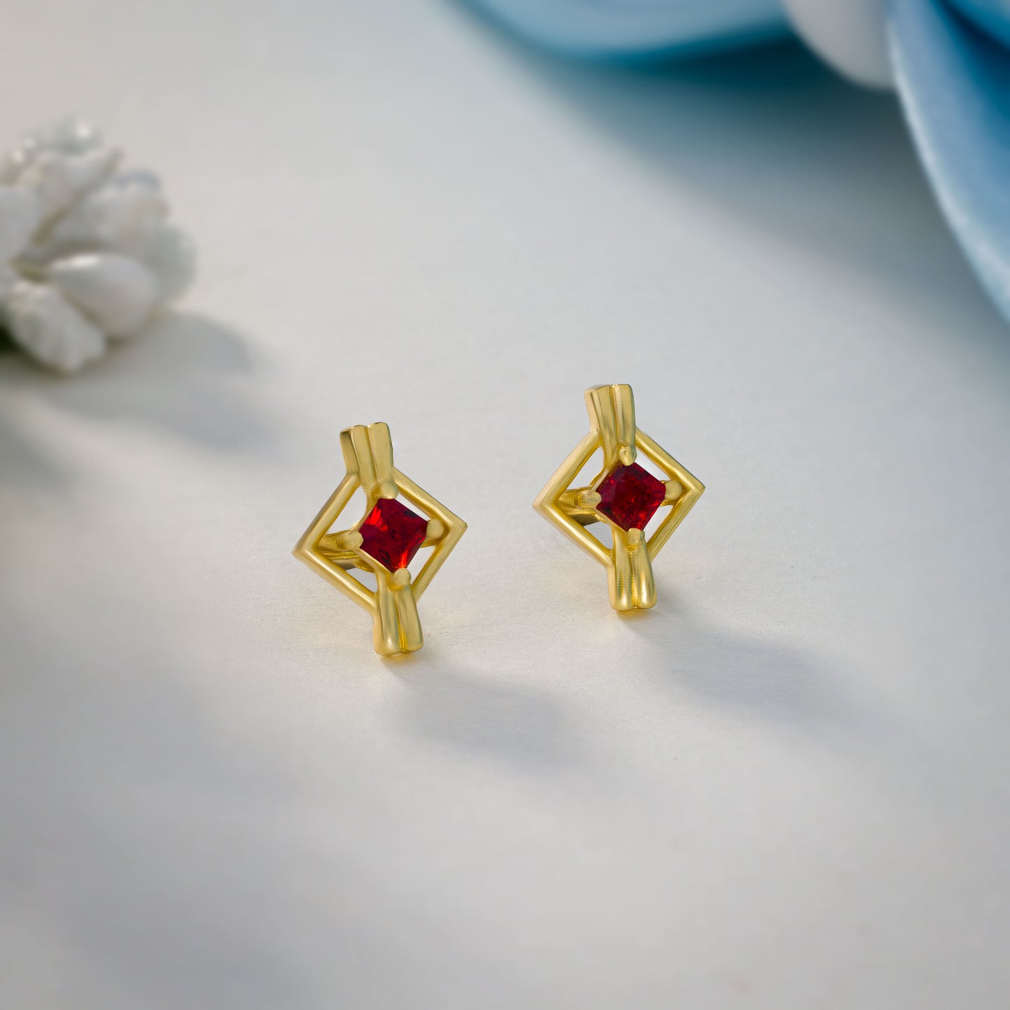 pair of golden earrings with a diamond