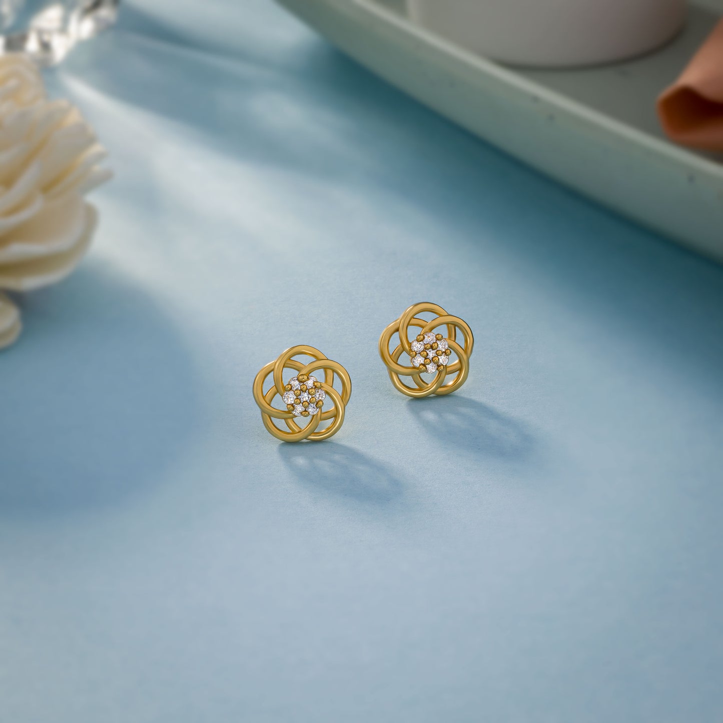 golden earrings with intricate flower