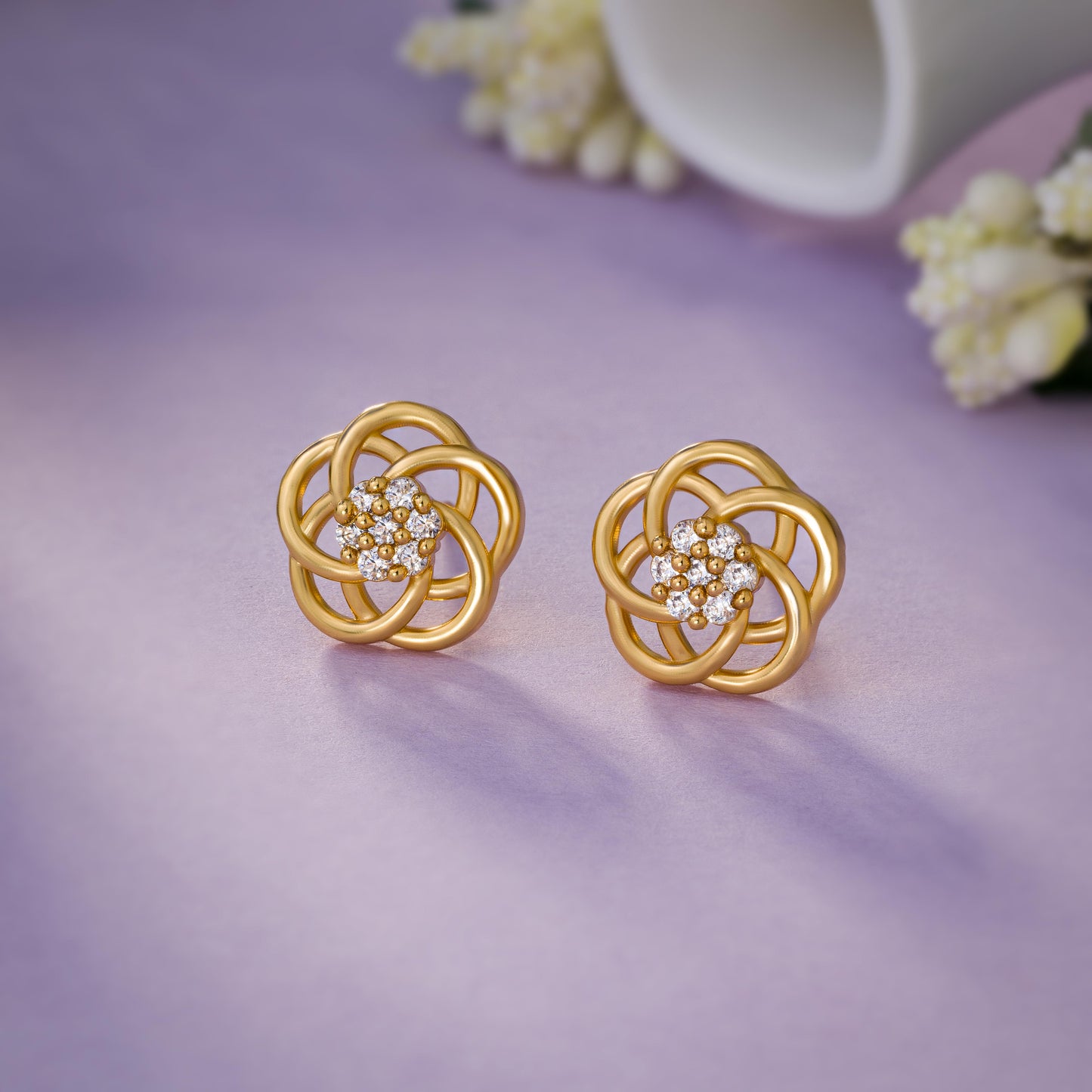 golden earrings with intricate flower