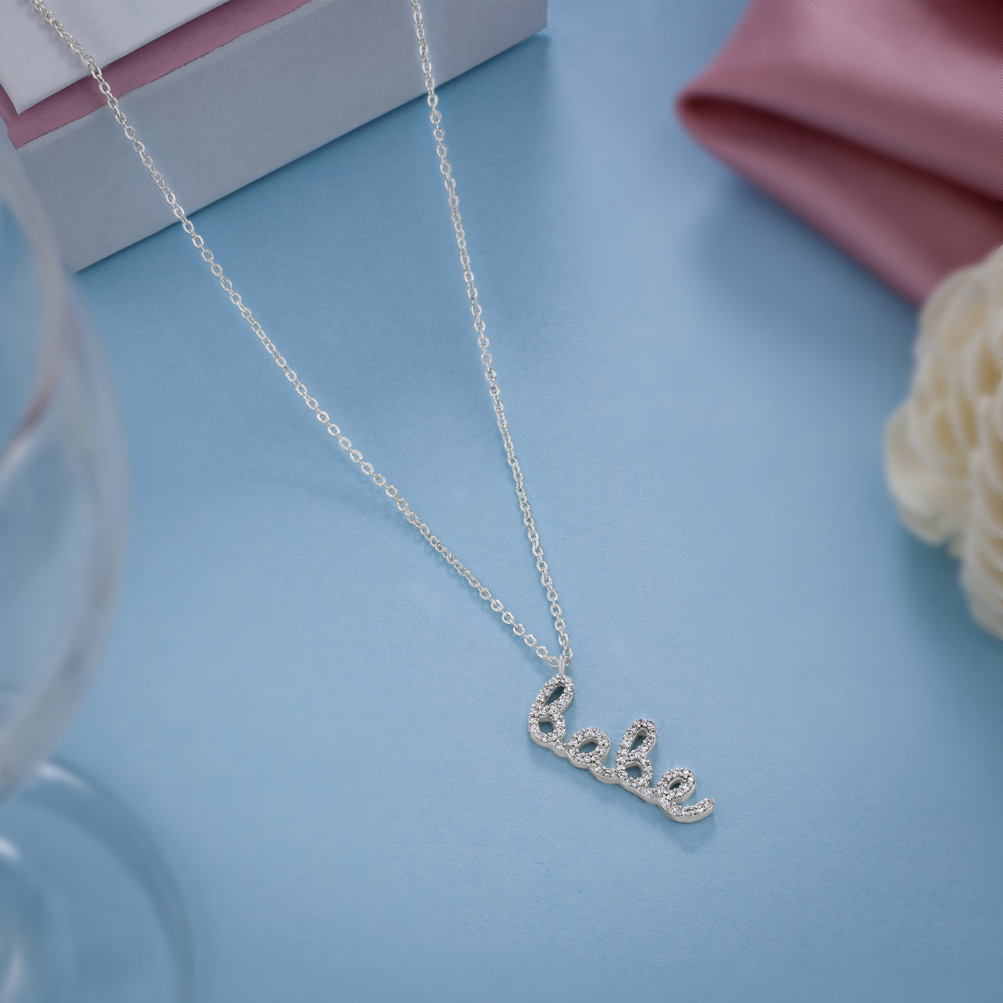 silver necklace with the word love on it