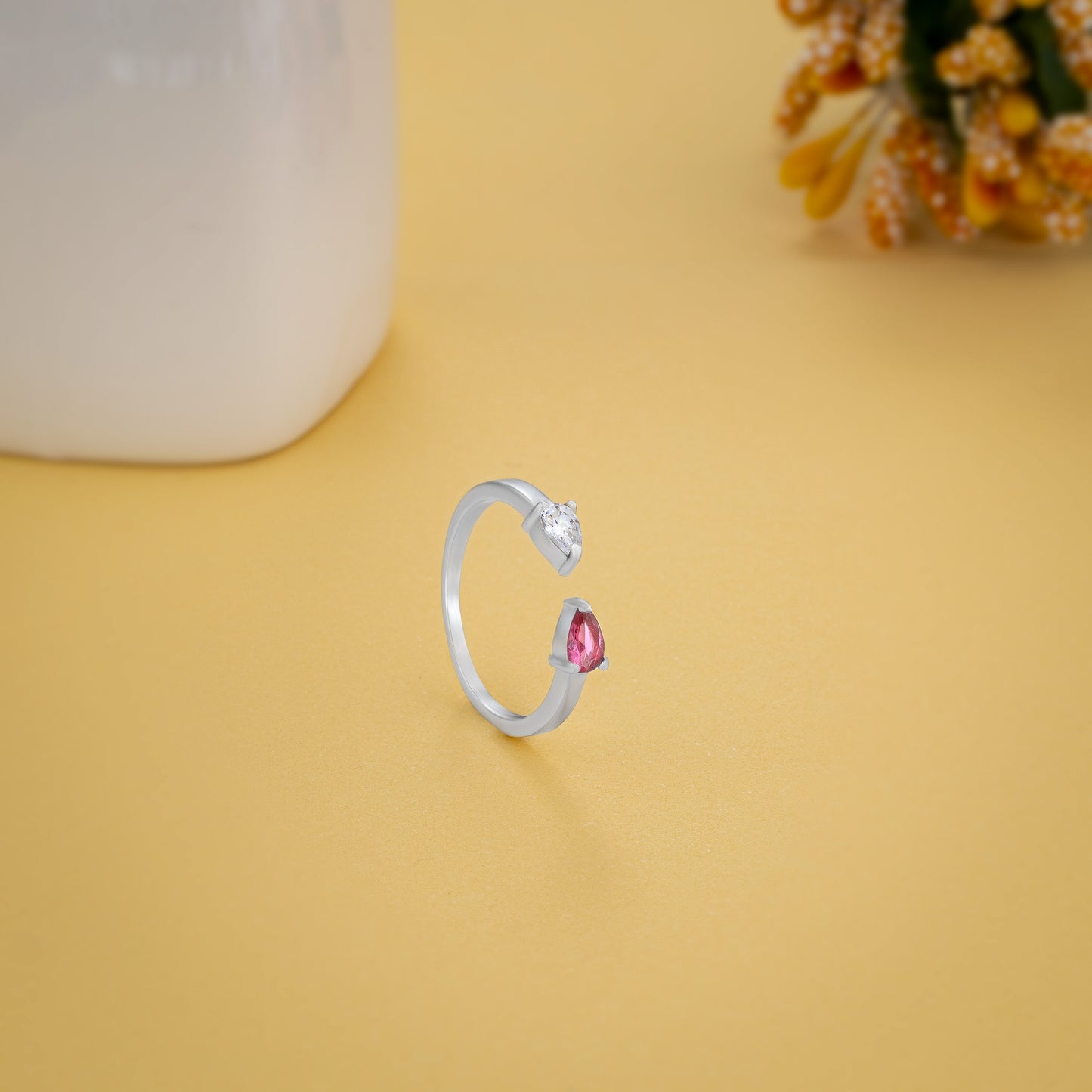 silver ring with a pink stone and a diamond