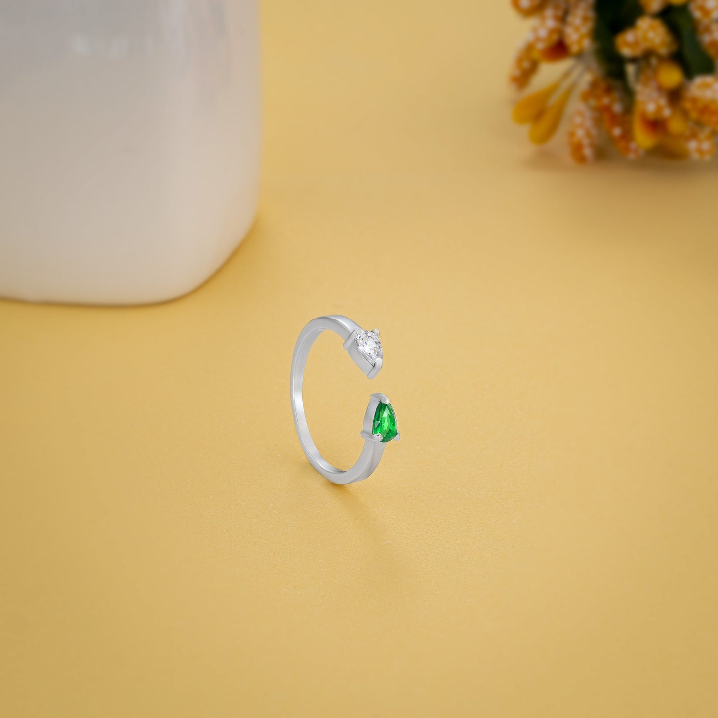 silver ring with a green stone and a diamond