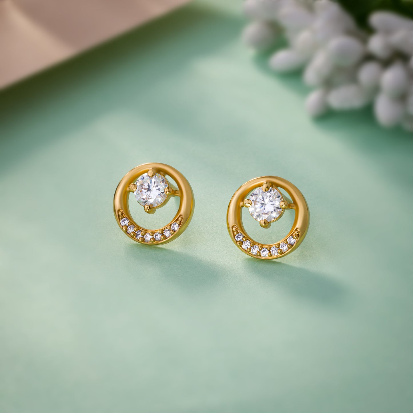 pair of golden plated earrings with sparkling stones