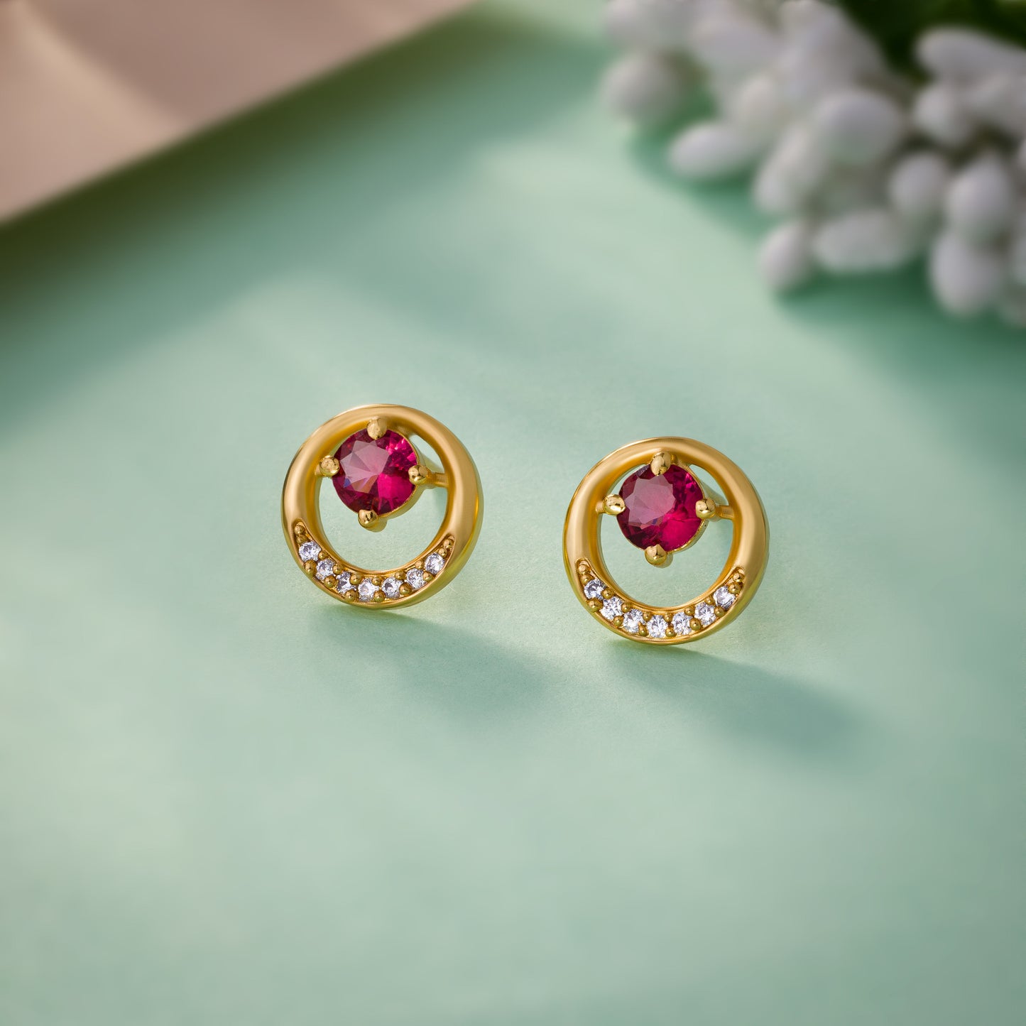 pair of golden plated earrings with sparkling stones