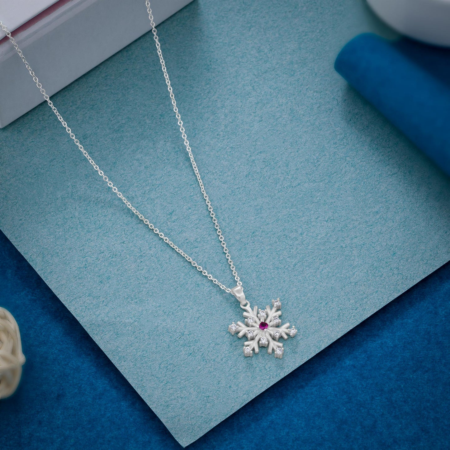 silver necklace with a flower charm