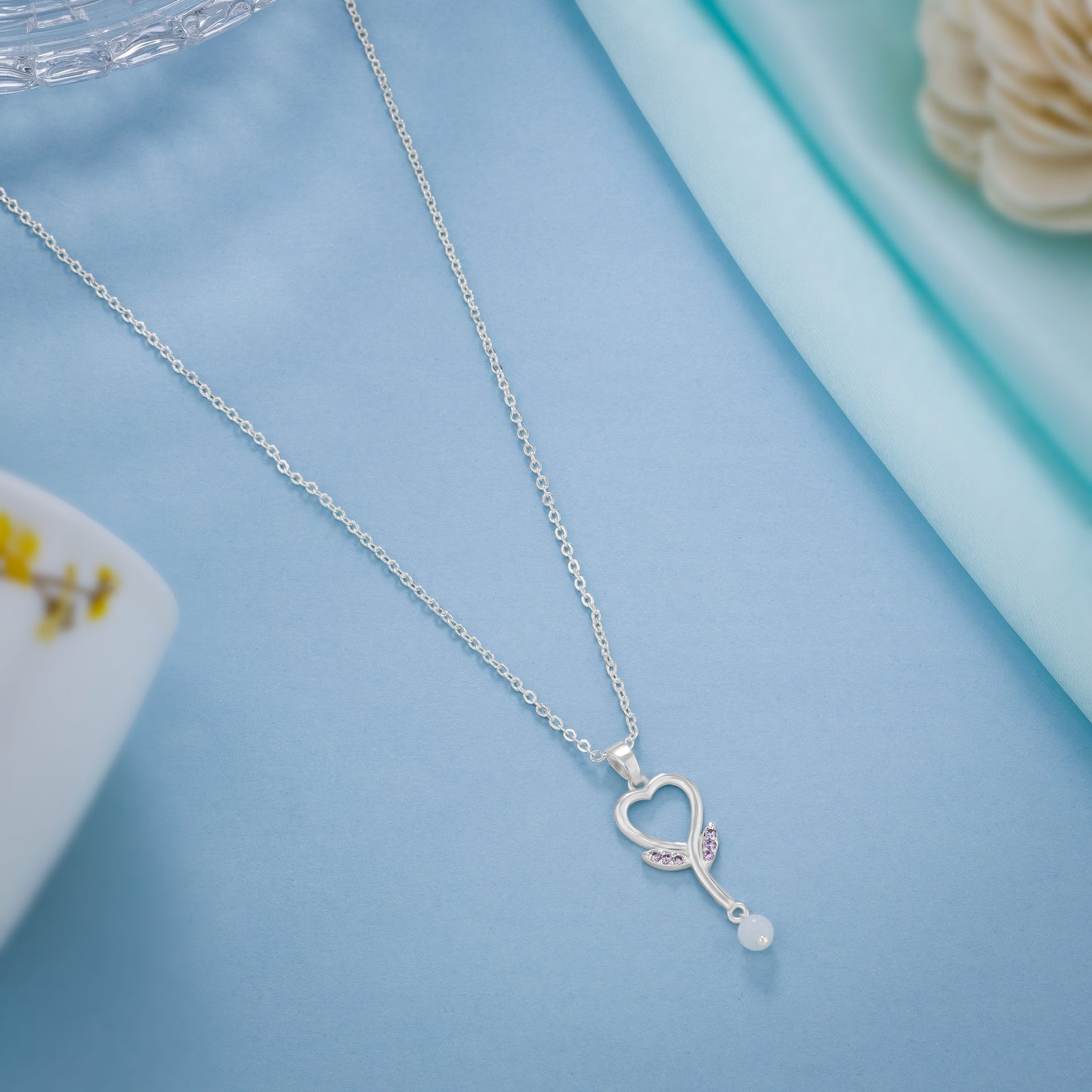 silver necklace with a diamond heart pendants