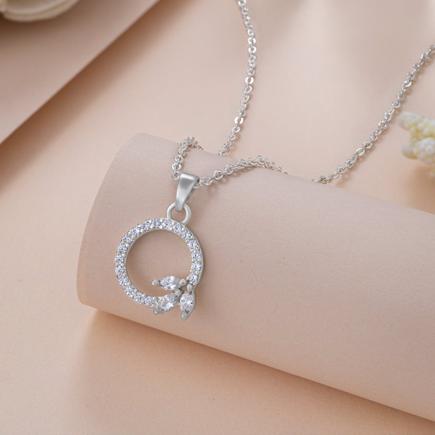 silver necklace with a diamond letter on it