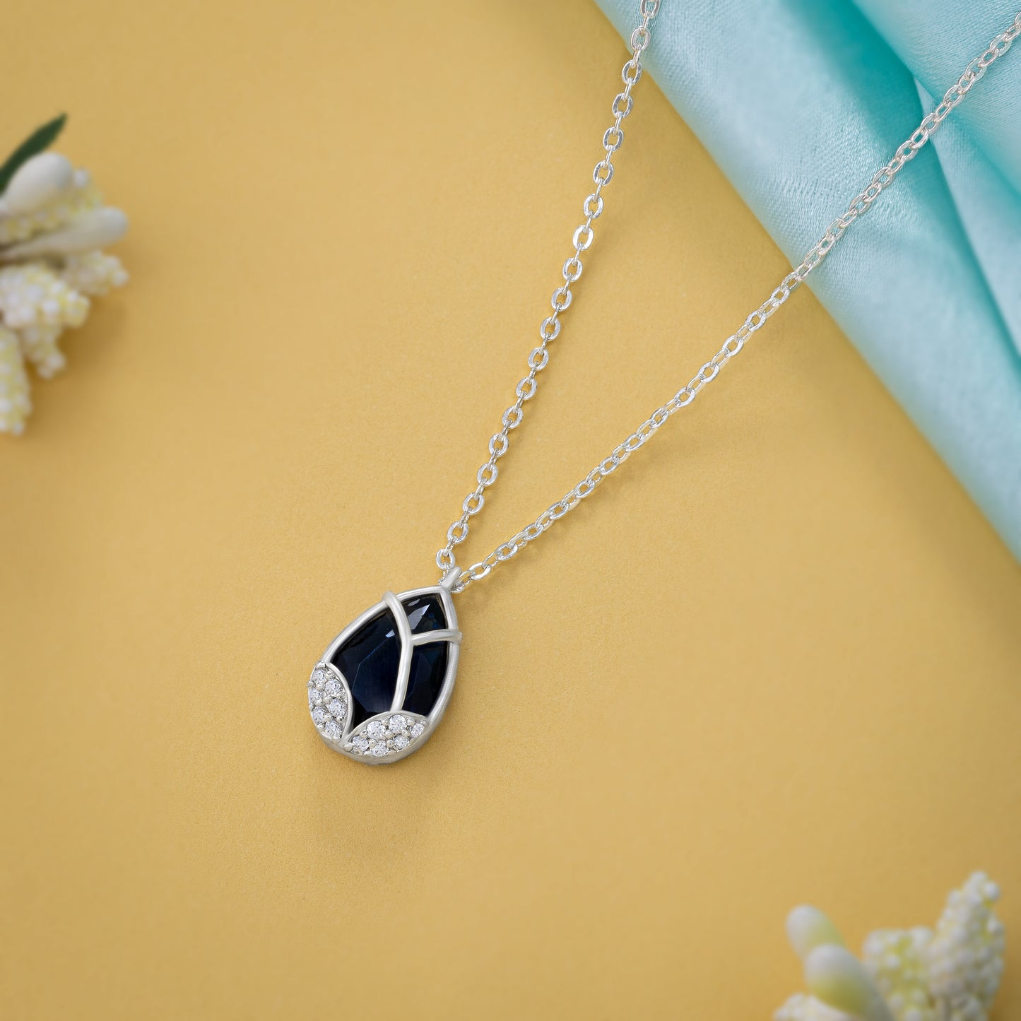 silver necklace with a large tear shaped pendant