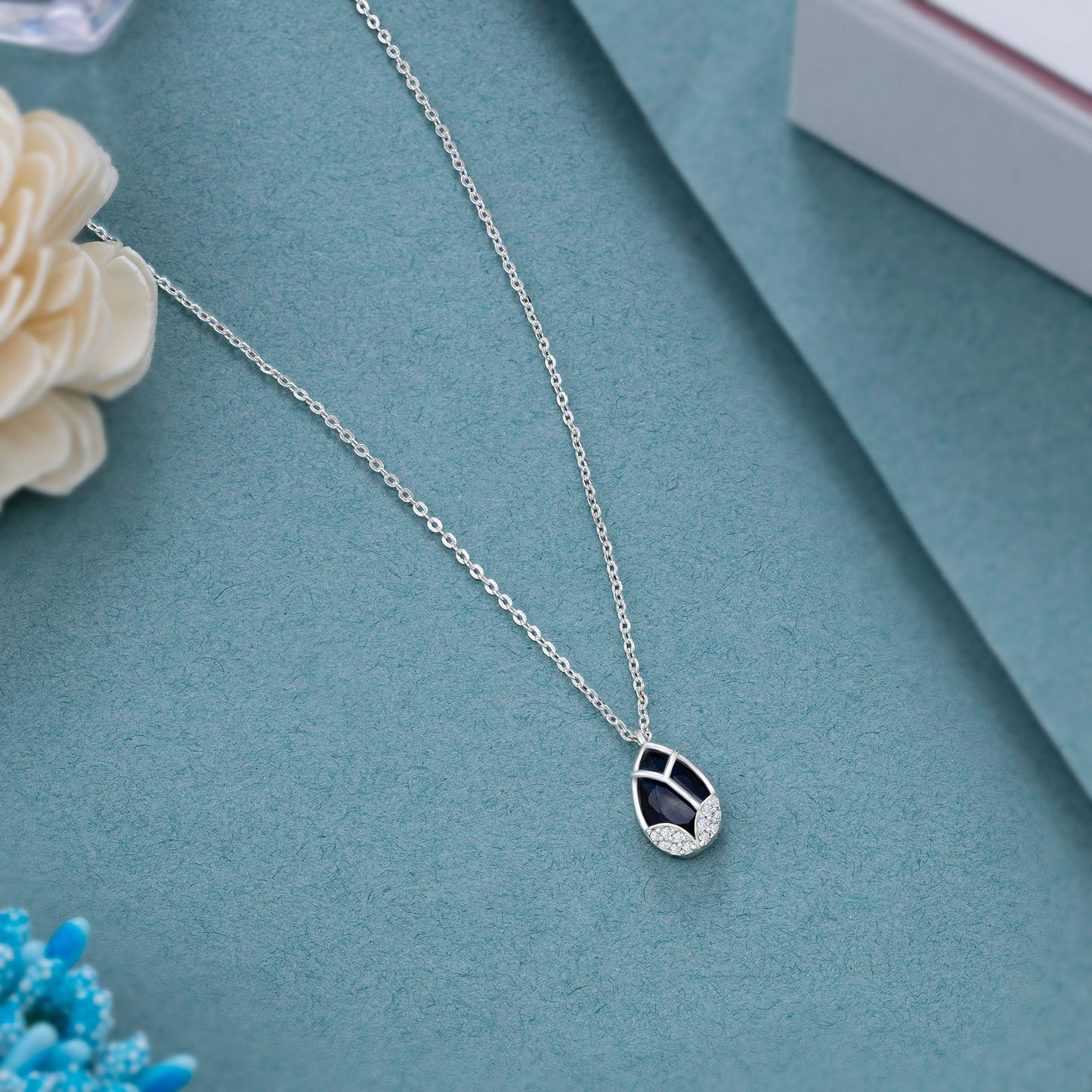 silver necklace with a large tear shaped pendant