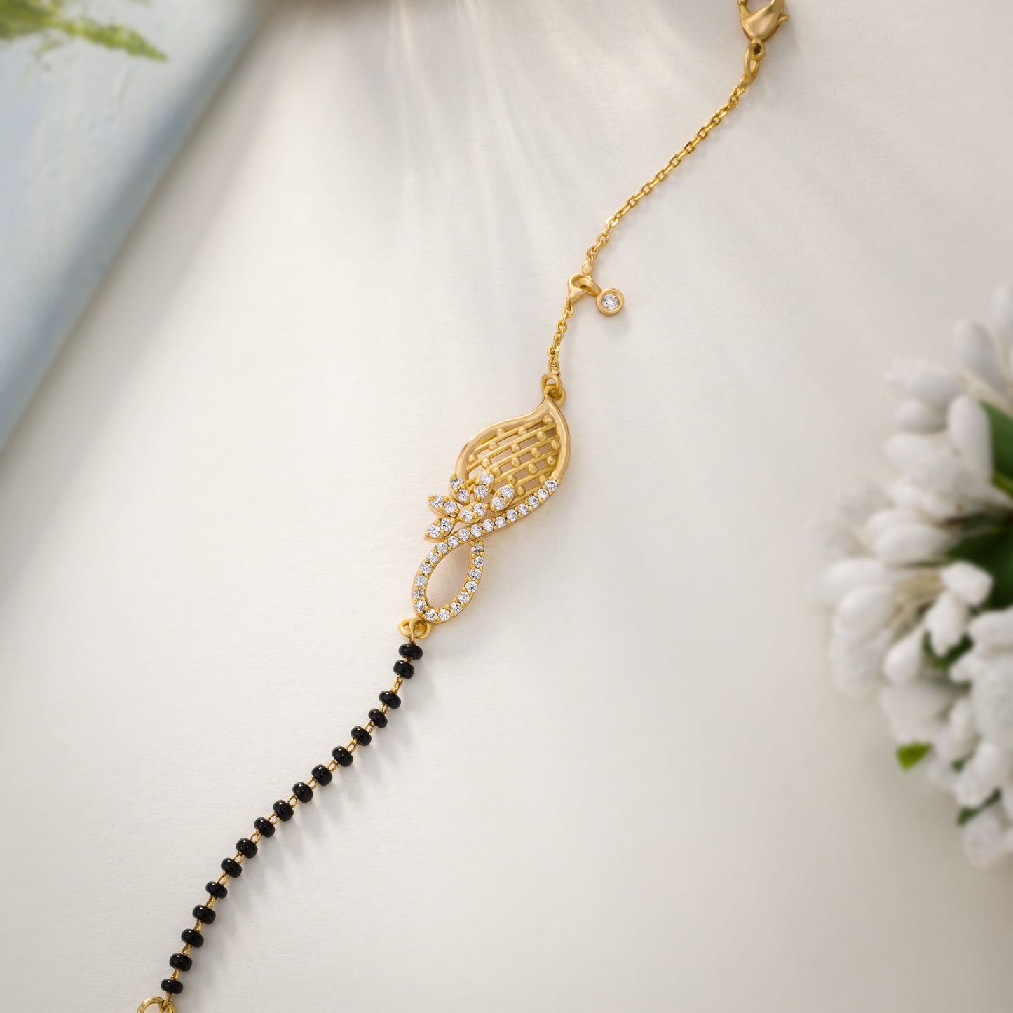 golden bracelet with black beads