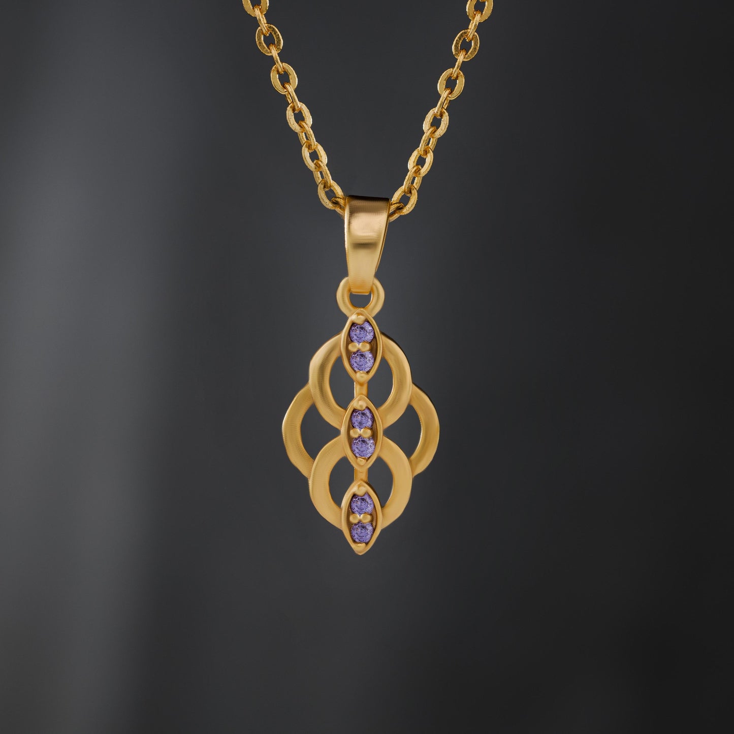 golden necklace with a purple stone