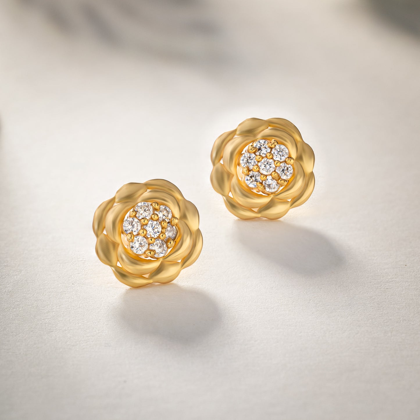 golden flower stud earrings with white diamonds