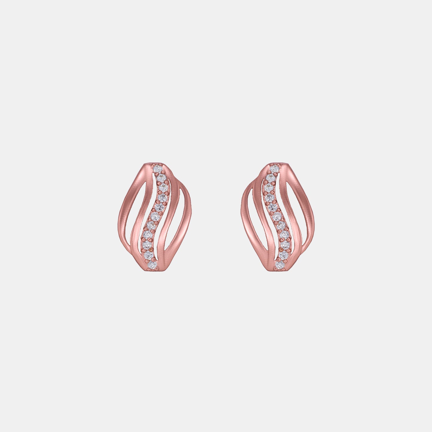 rose gold earring with diamonds on a ruler