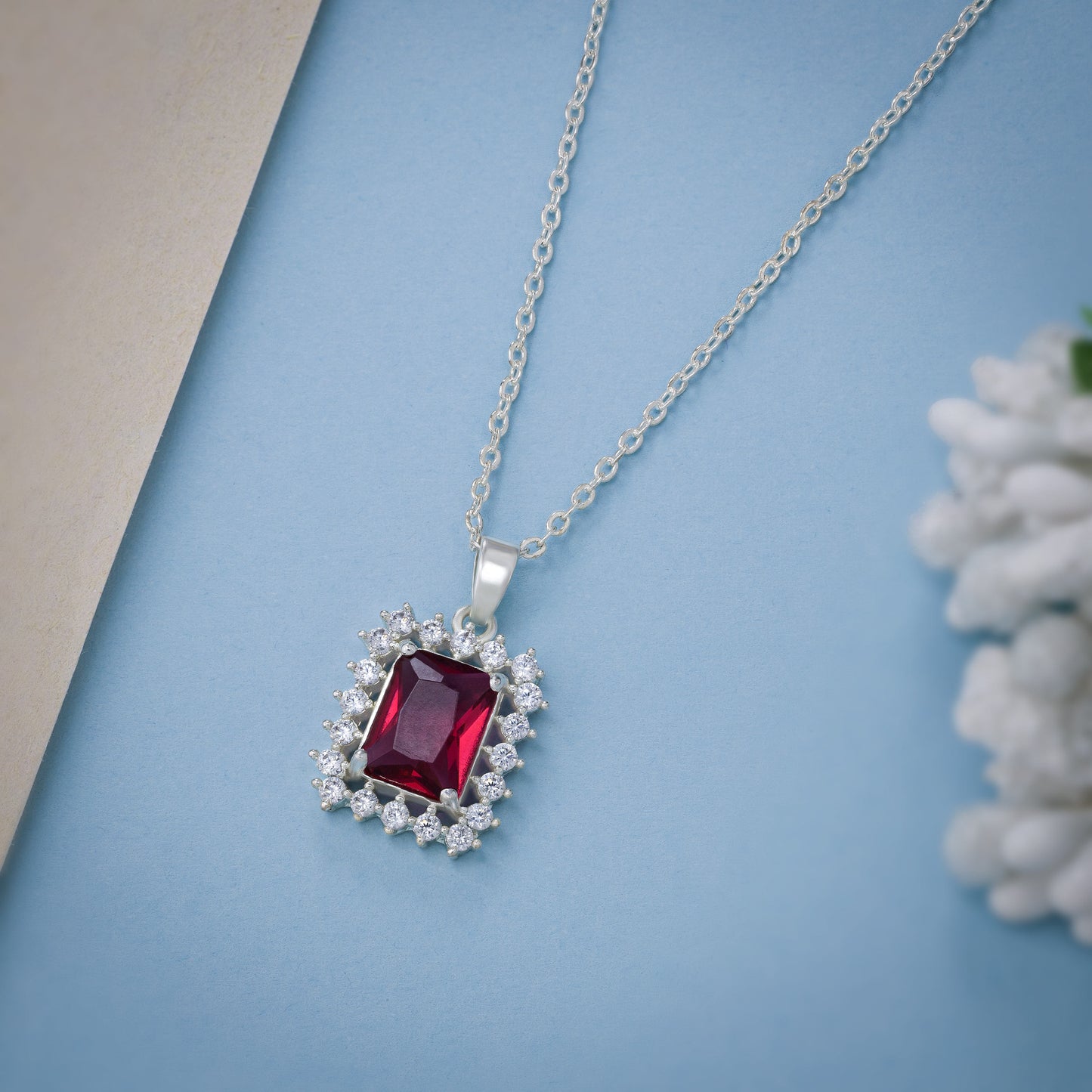 silver necklace with a red color stones