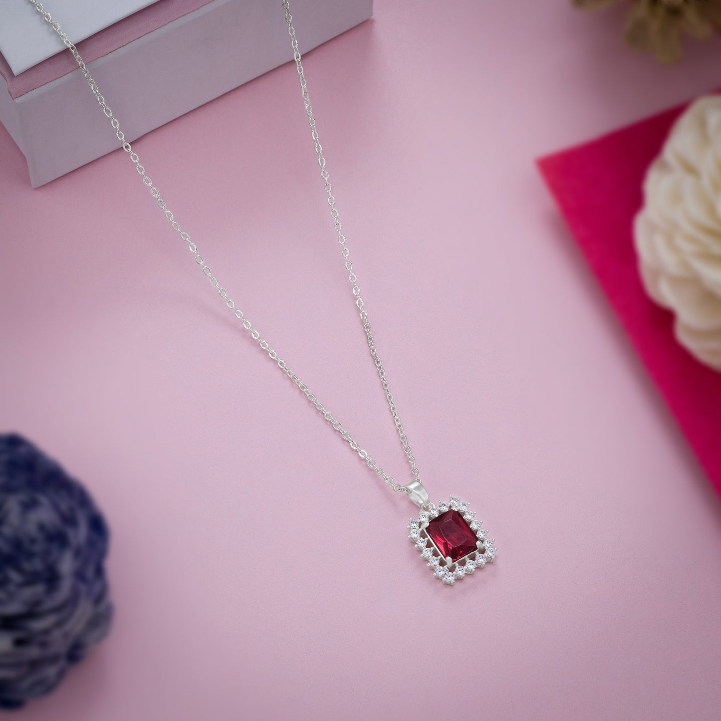 silver necklace with a red color stones