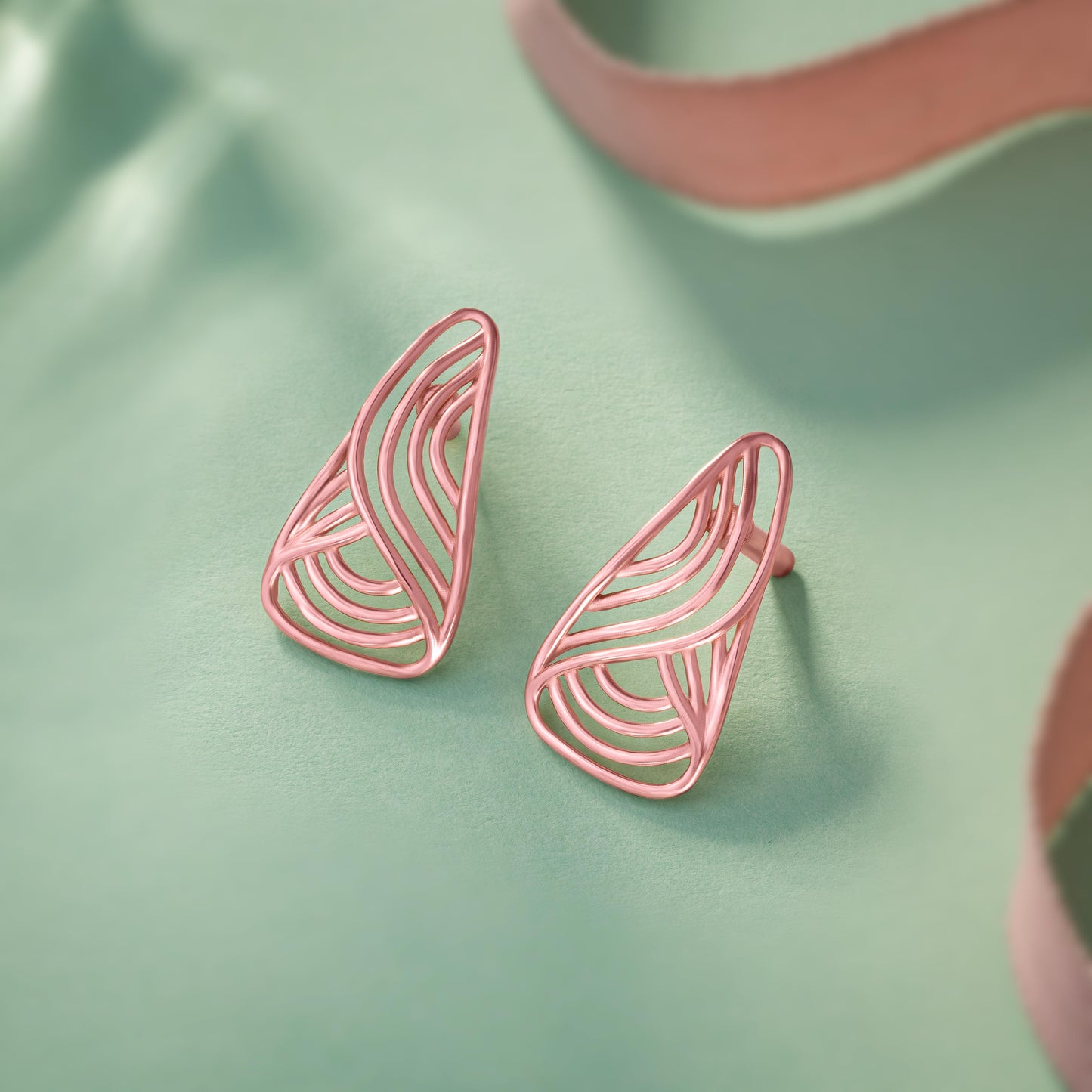 pair of rose gold earrings