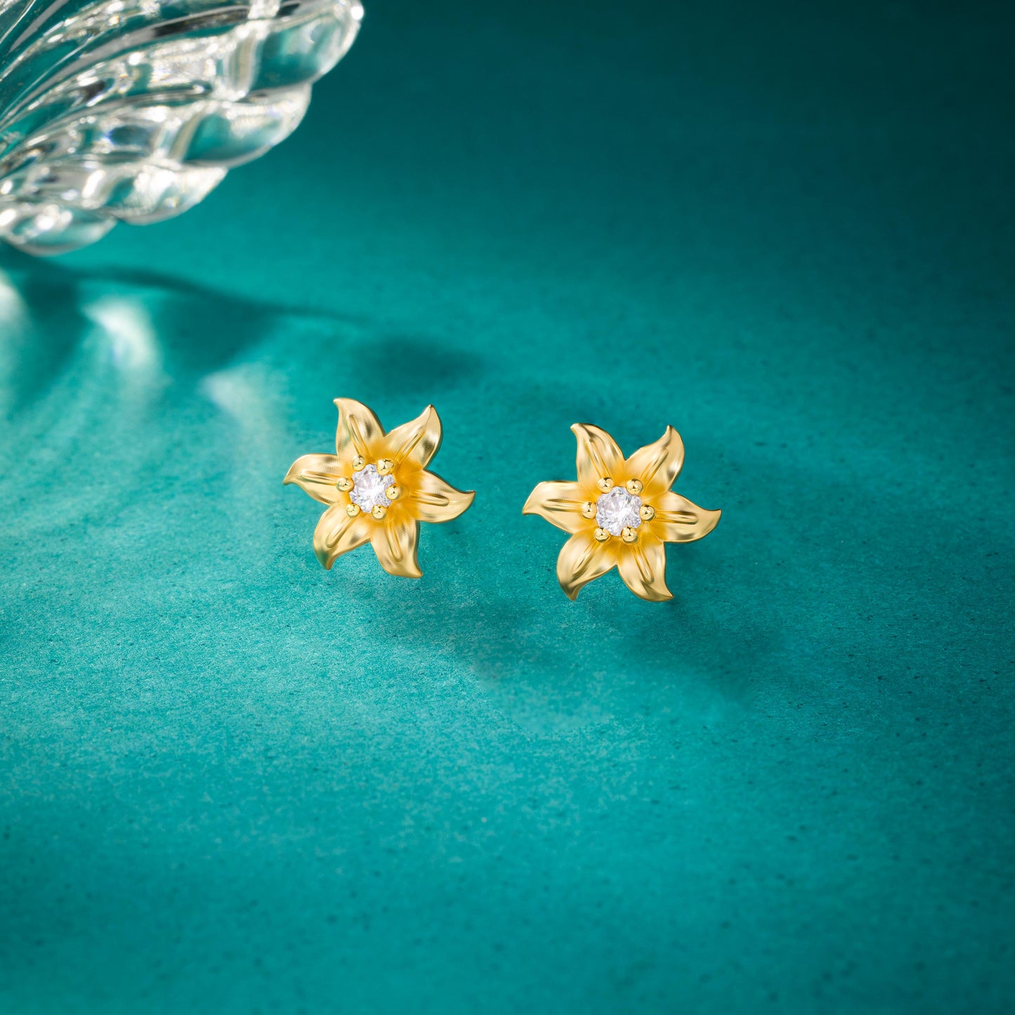 pair of golden earrings with white stones