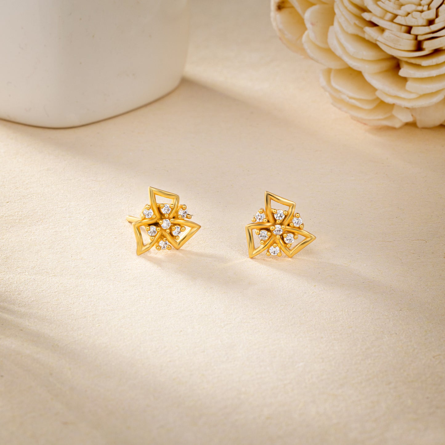 pair of golden earrings with stones