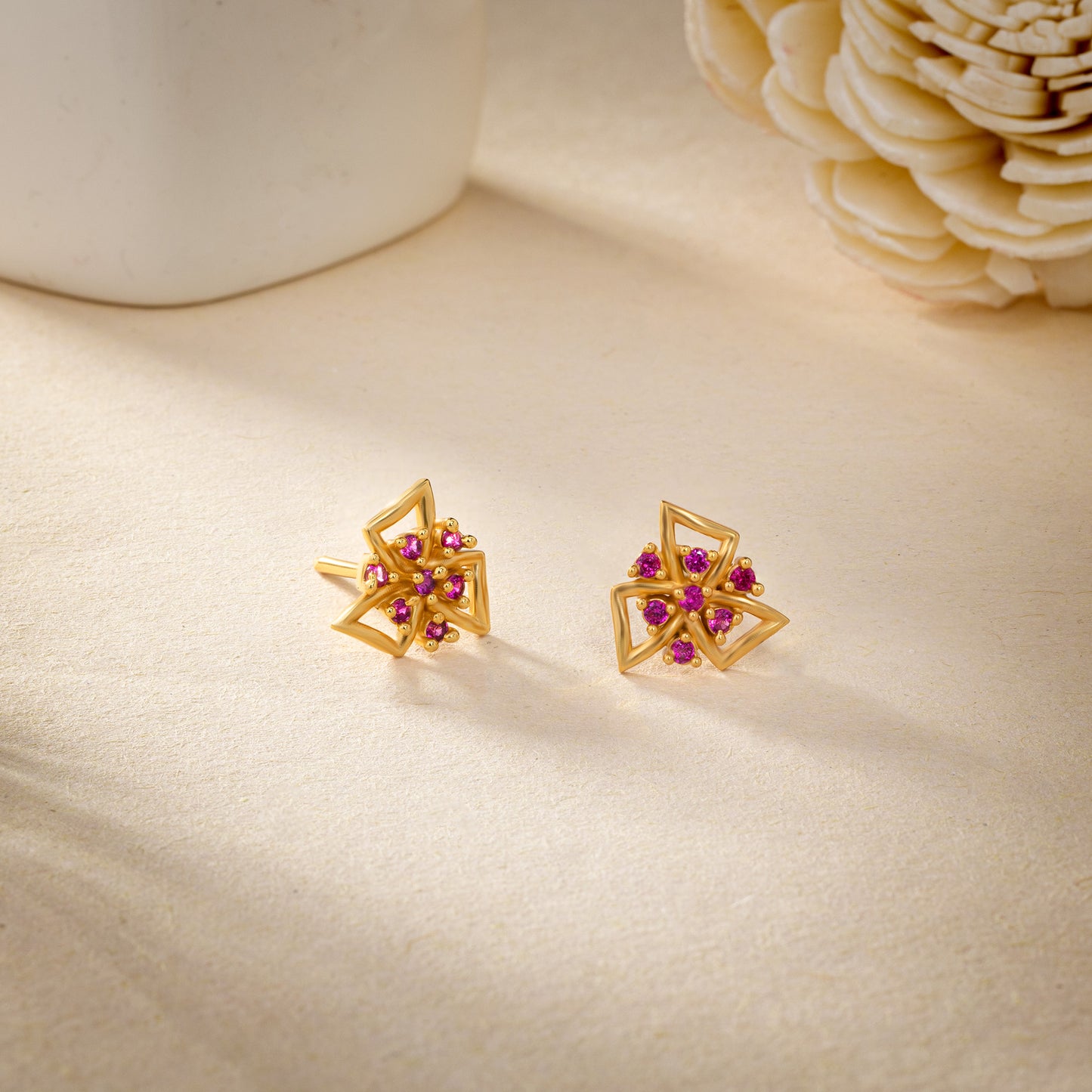 pair of golden earrings with stones