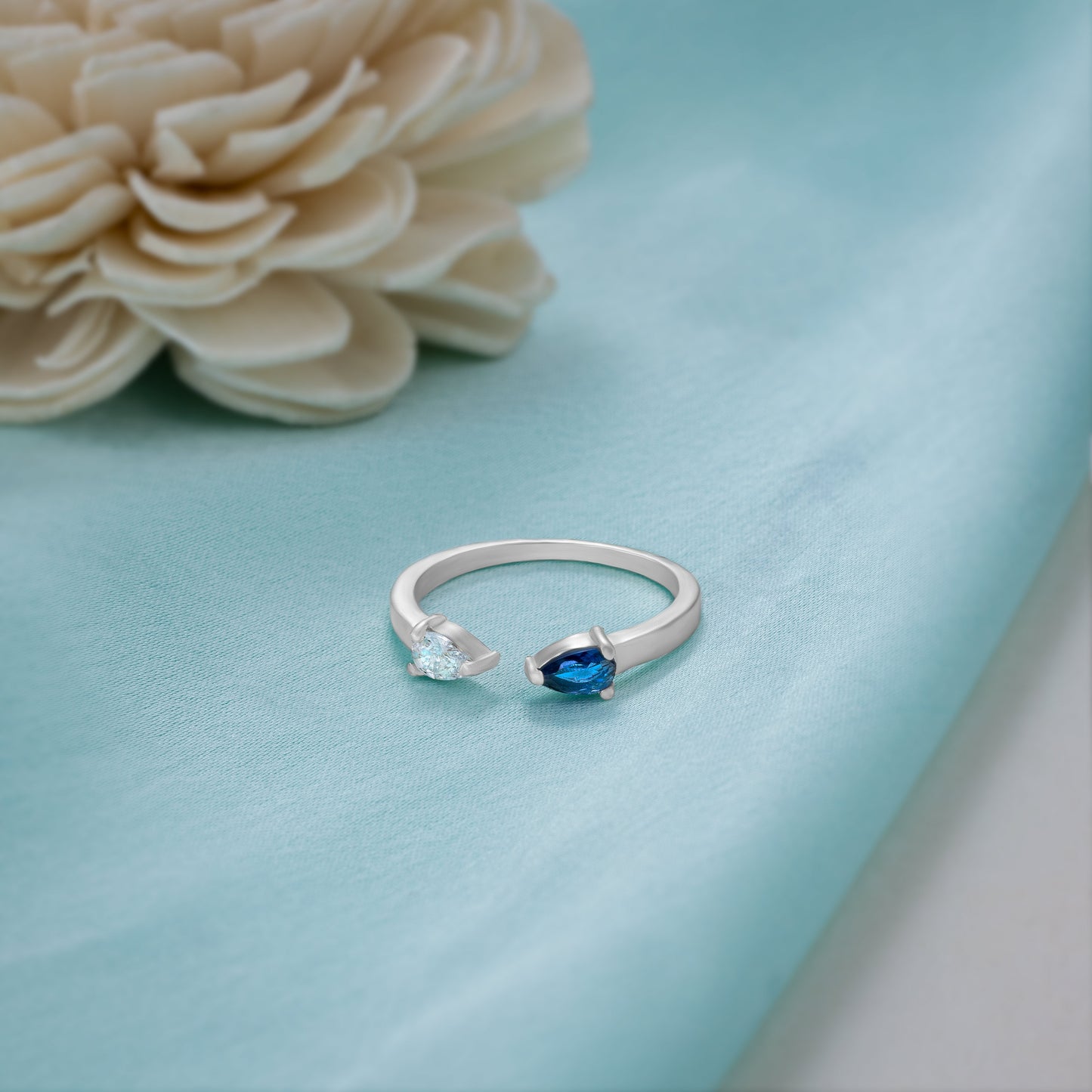 silver ring with a blue stone and a diamond